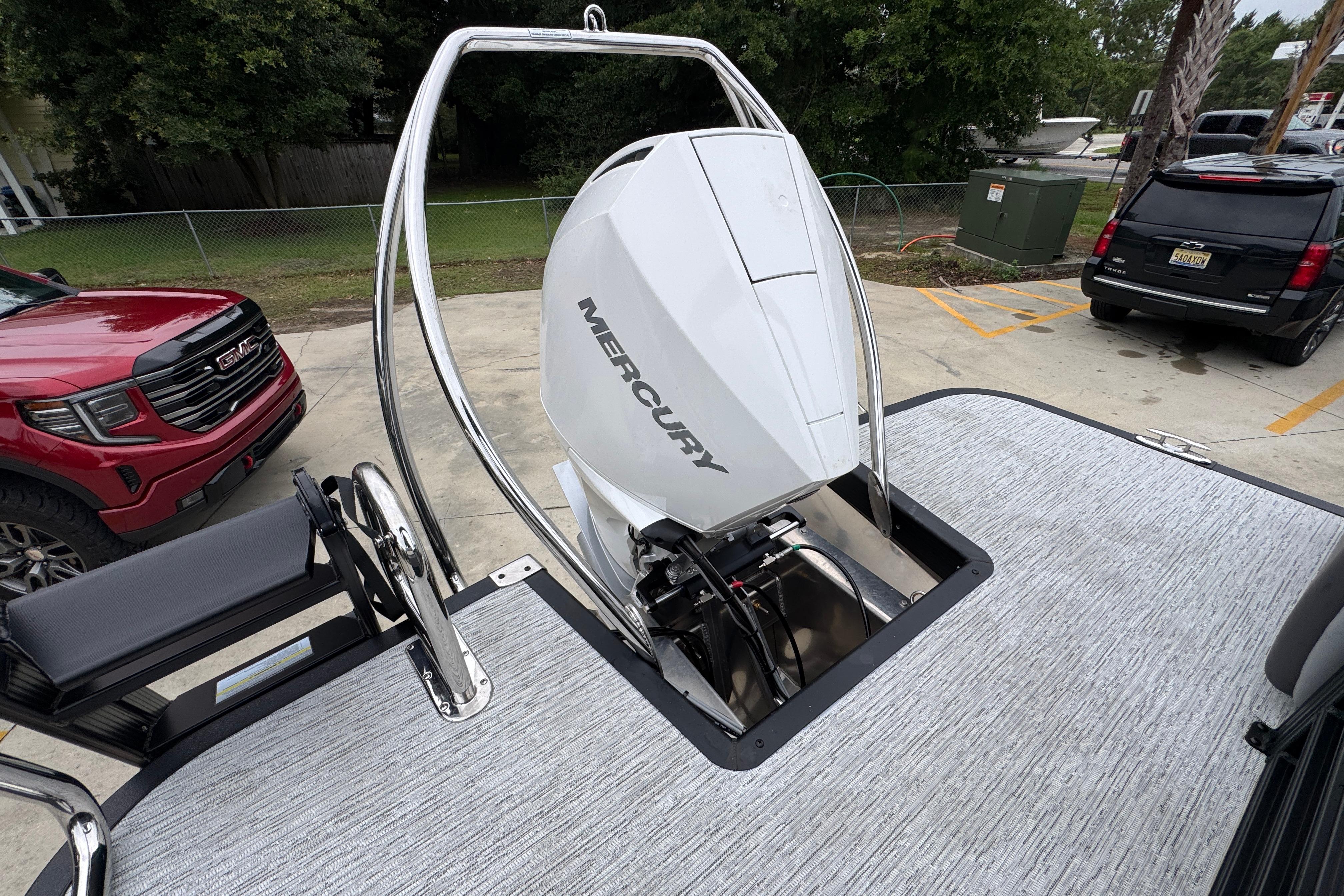 2027 Bennington 24 MFB boat with Mercury outboard motor in a parking lot.