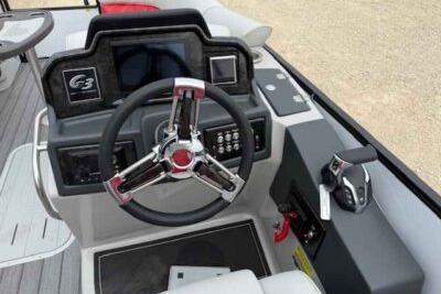 2025 SunCatcher Elite 324 RC boat dashboard with steering wheel and controls.