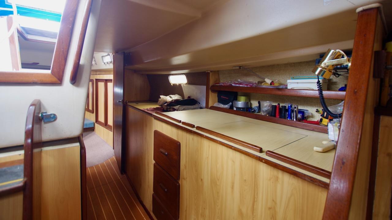 1981 Morgan Out Island 41 yacht interior with wooden cabinetry and shelving.