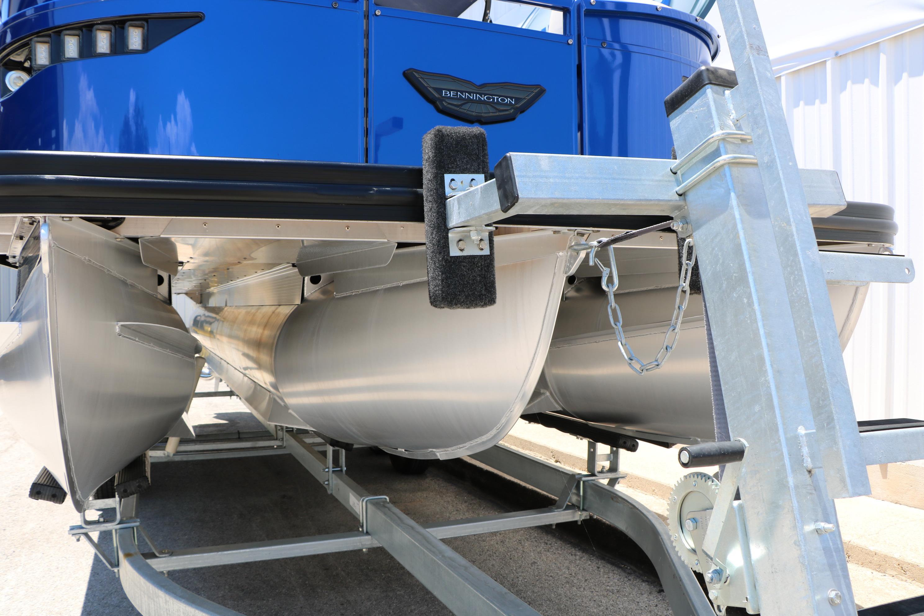 2024 Bennington 23 RX Swingback pontoon boat on trailer, showcasing sleek aluminum pontoons.