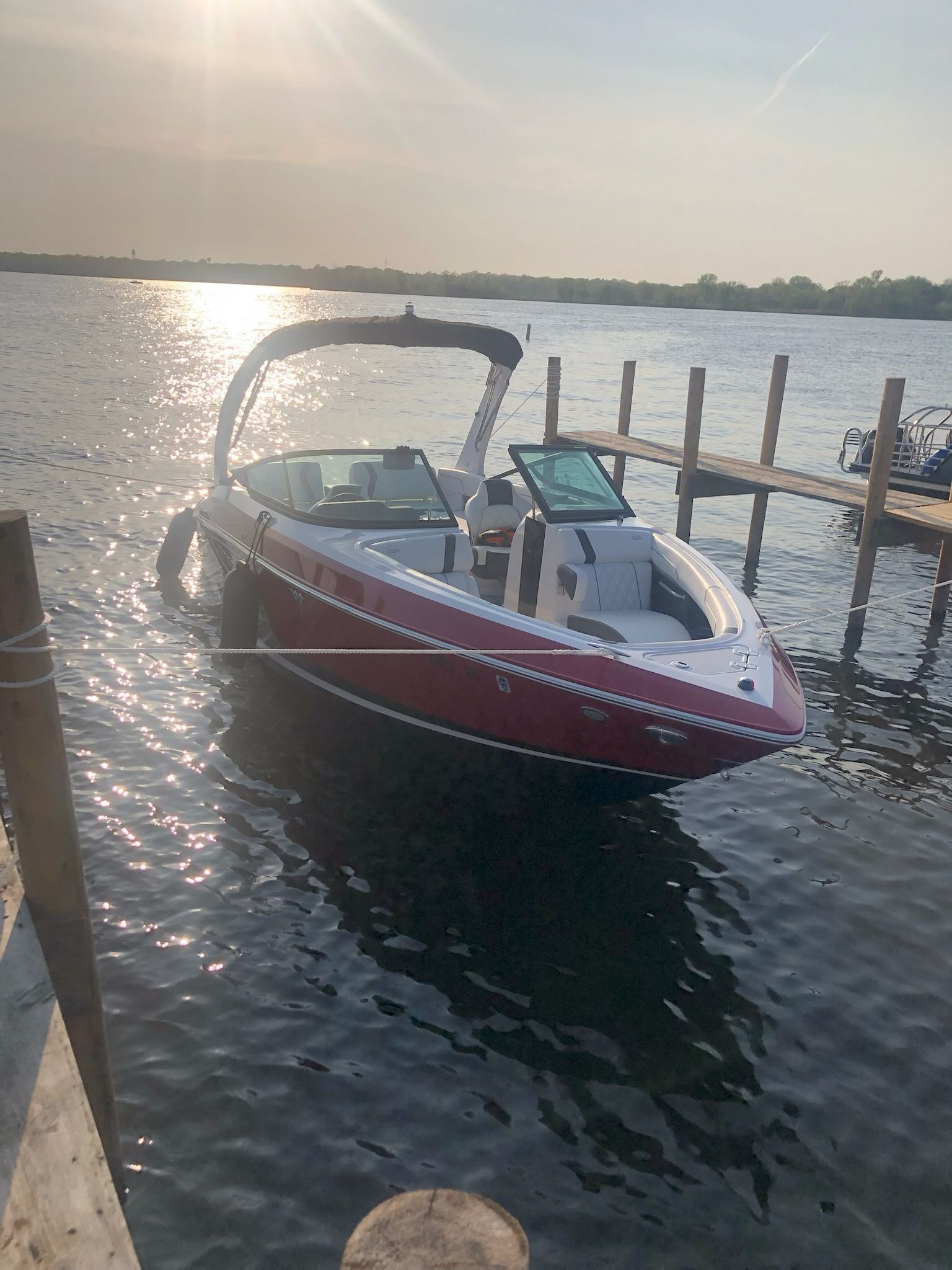 2019 Regal 25 RX Surf boat docked at sunset.