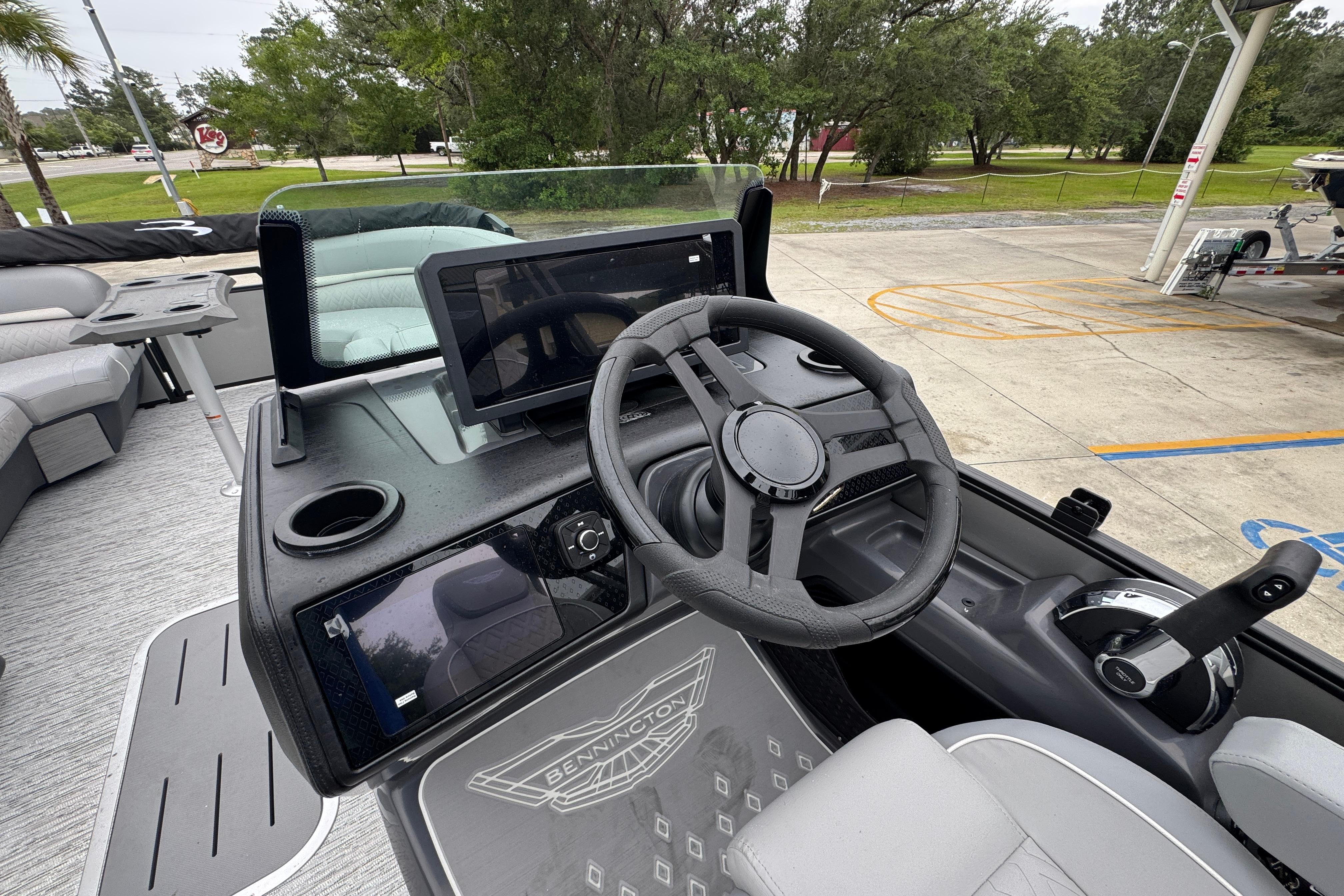 2027 Bennington 24 MFB boat dashboard with steering wheel and digital displays.