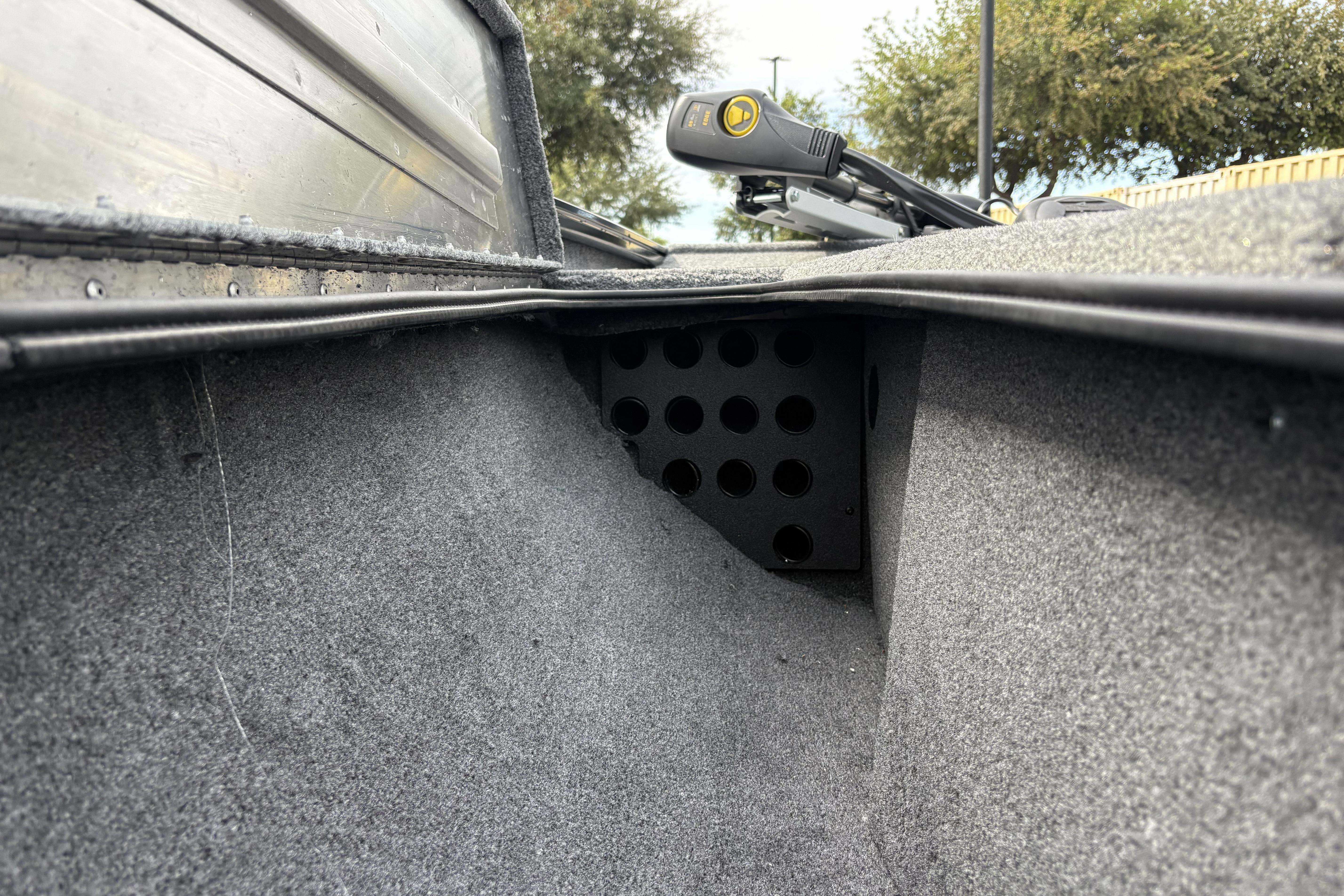 Interior view of 2026 Tracker Pro Team 195 boat, showcasing carpeted storage area.