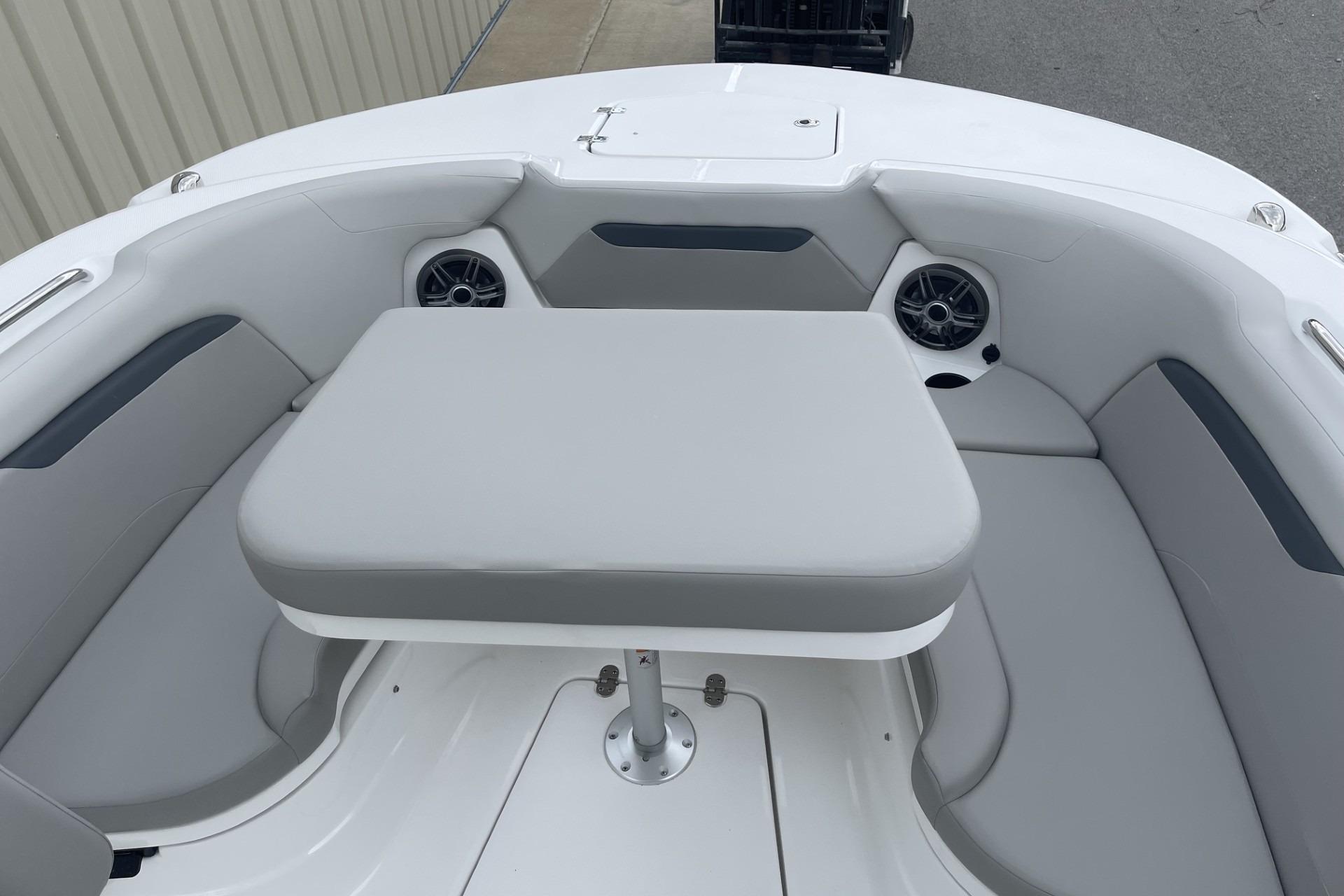 2026 Hurricane Center Console 24 OB boat interior with cushioned seating and table.