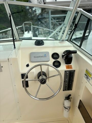 The image shows the helm of a 2008 Parker 2310 Walkaround boat with Garmin equipment.