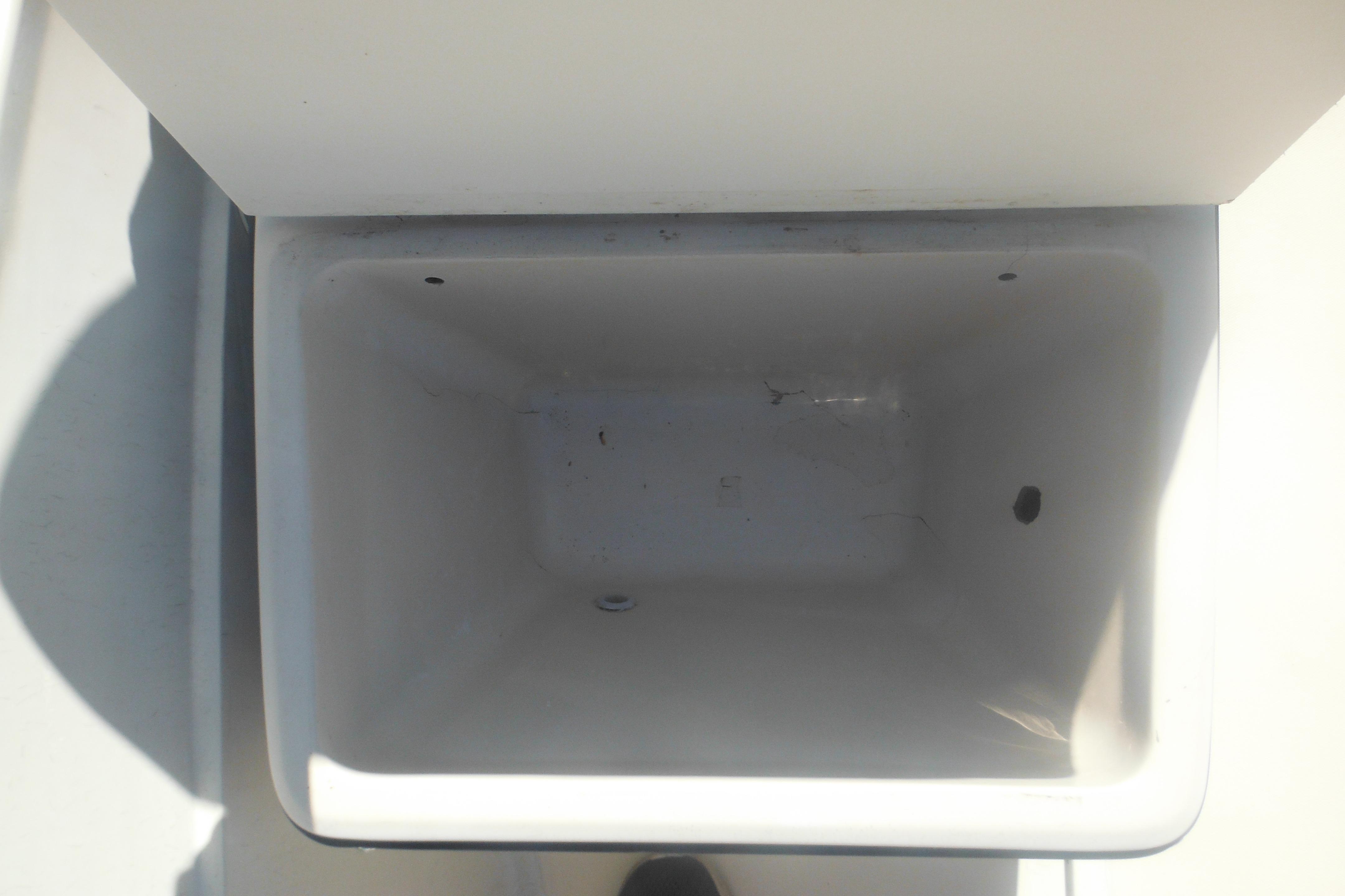 Empty storage compartment on a 1991 Boston Whaler 16 SL boat.