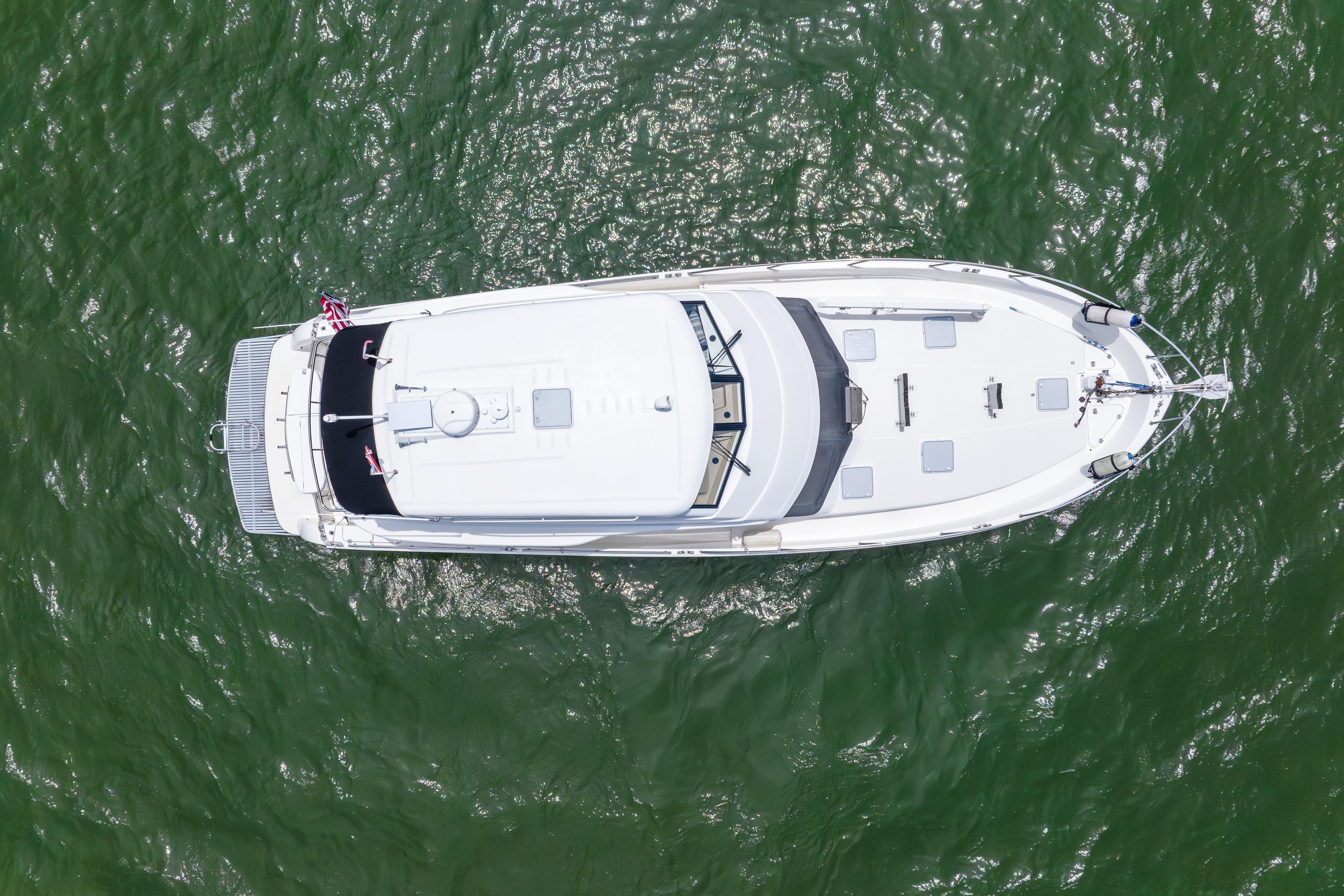 Aerial view of 2008 Maritimo 52 yacht on green water.