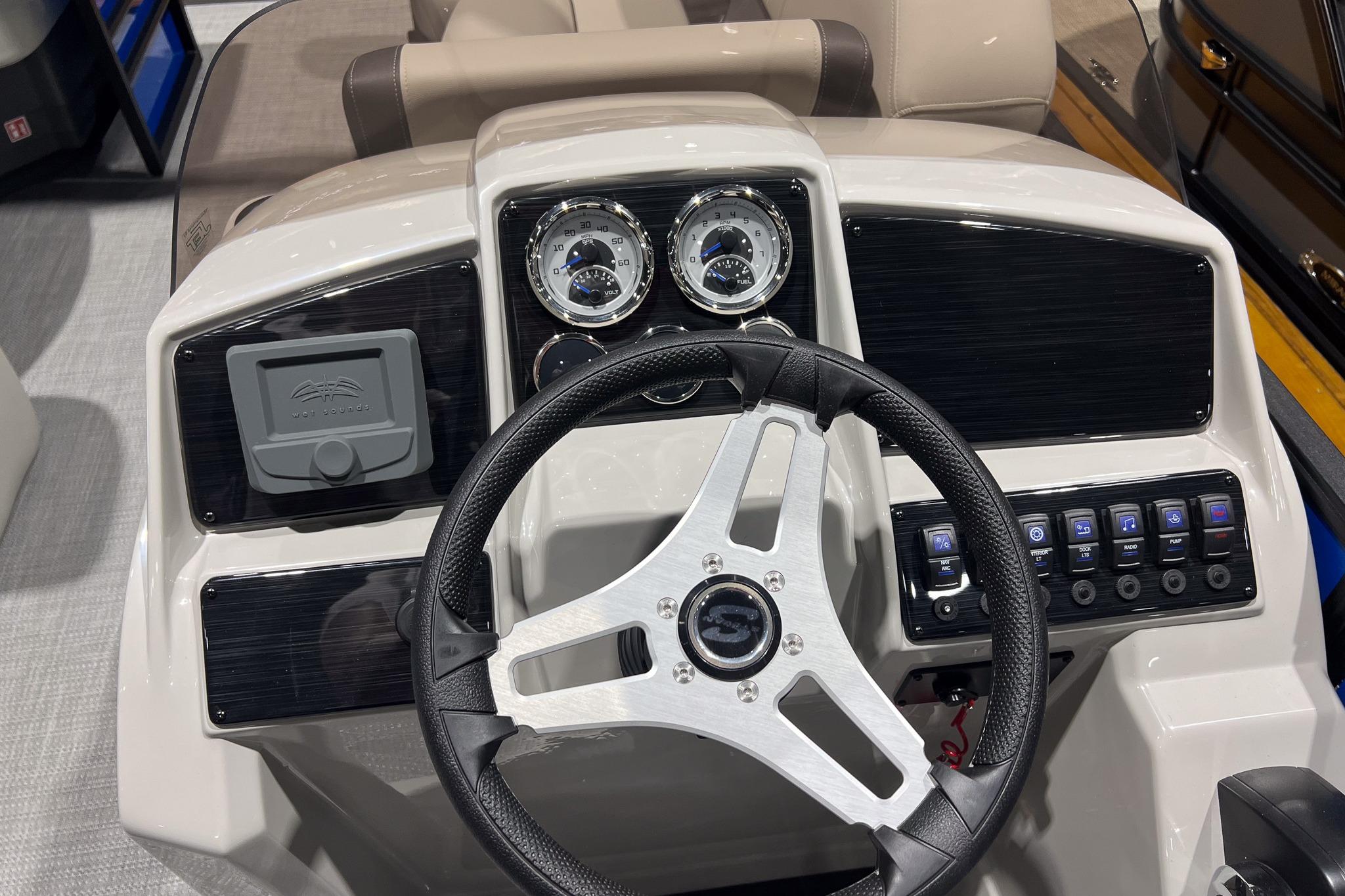 2026 Sylvan Mirage 822 CLZ boat dashboard with steering wheel and control panel.