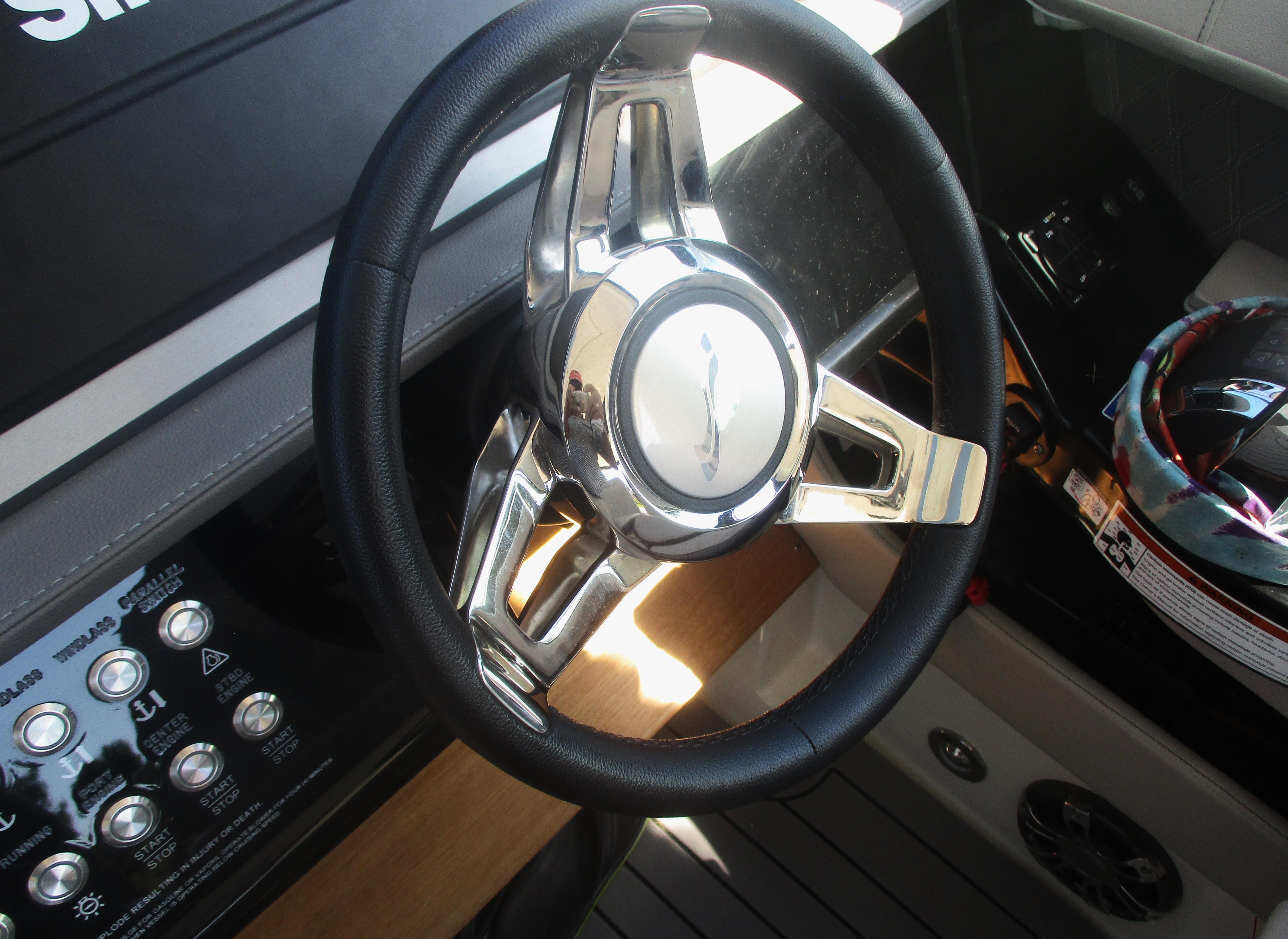 Steering wheel of 2021 Sea Ray 400 SLX Outboard boat, featuring sleek design and controls.