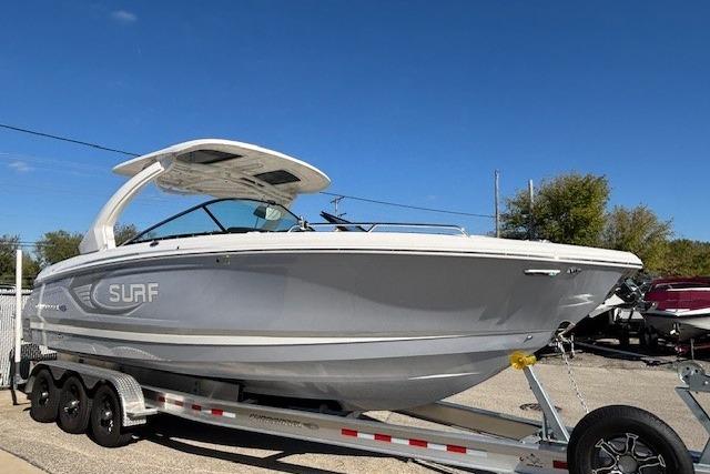2024 Chaparral 30 Surf boat on trailer, sleek design, ready for adventure.