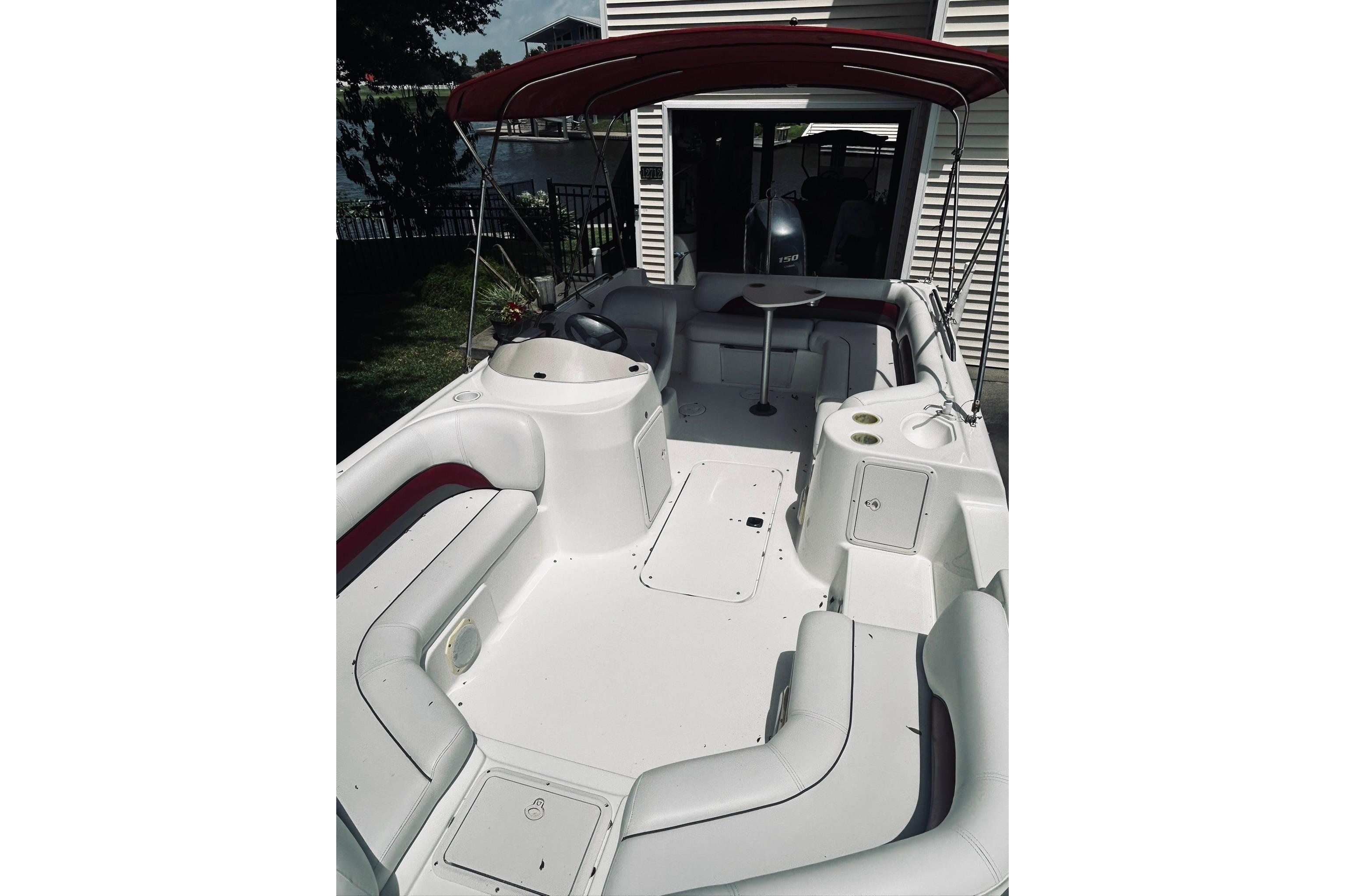 2013 Hurricane SunDeck Sport 201 OB boat interior with seating and canopy.