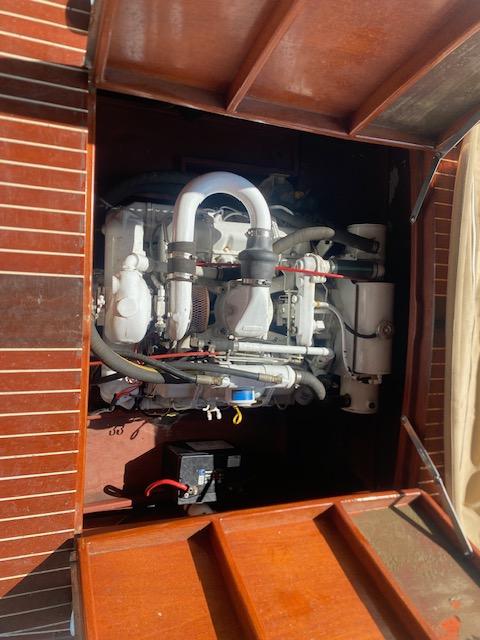 Engine compartment of a 2000 Grand Craft Classic Runabout boat, showcasing detailed mechanical components.
