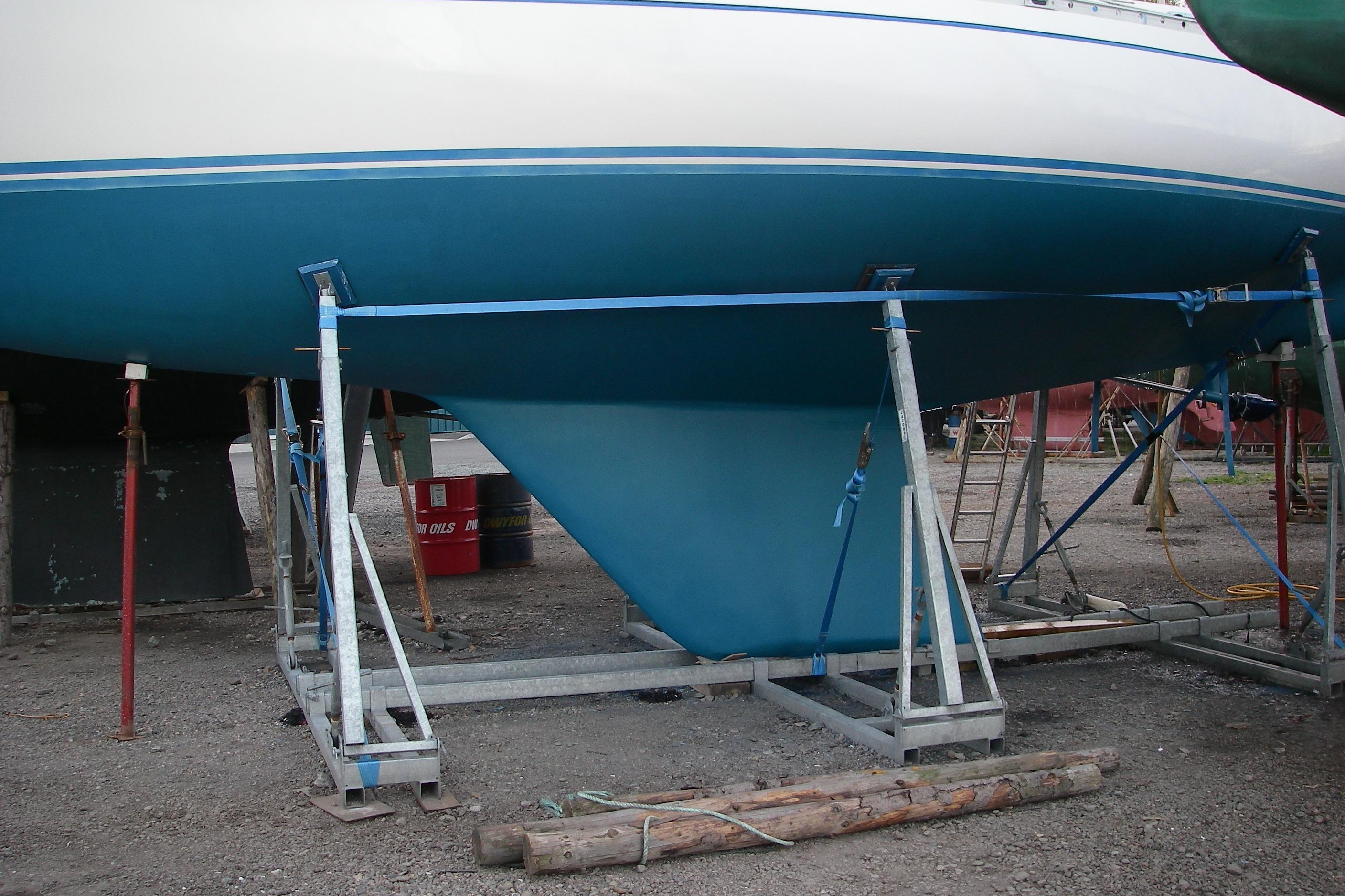 1980 Nautor Swan 411 sailboat hull on stands, undergoing maintenance.