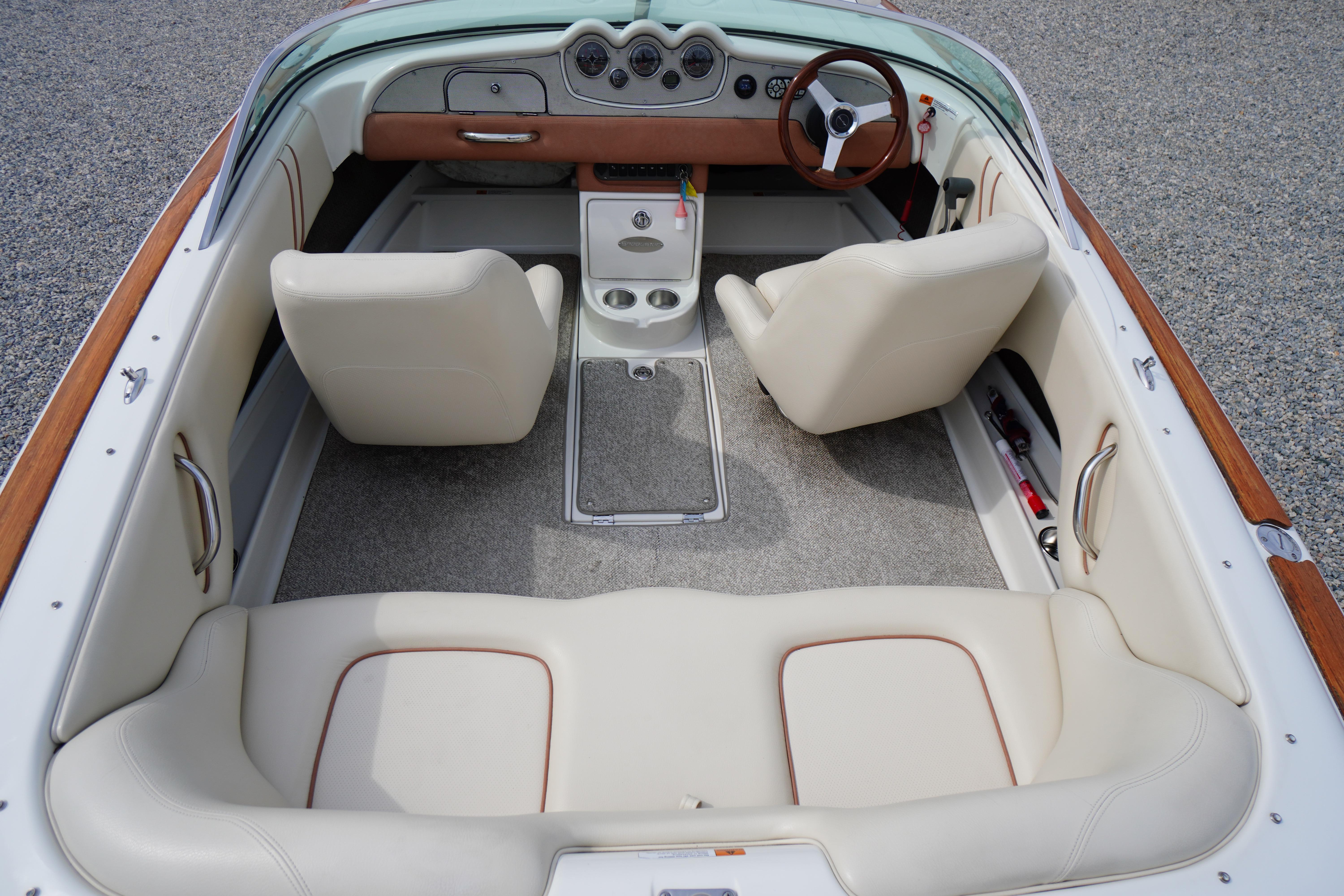 2005 Chris Craft Speedster Heritage boat interior with beige leather seats and wooden accents.