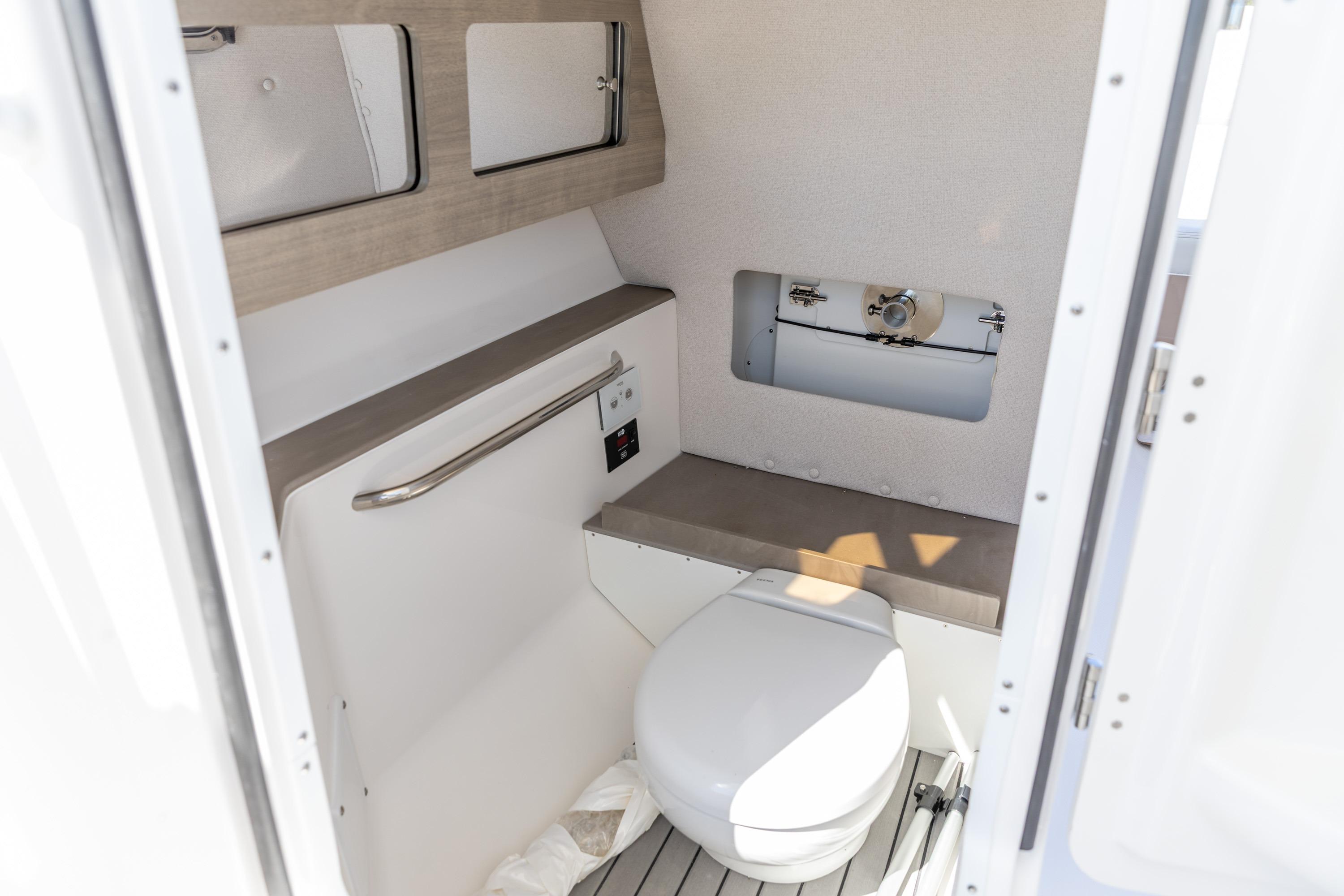 2026 Edgewater 248CX Crossover boat interior bathroom with modern fixtures and compact design.