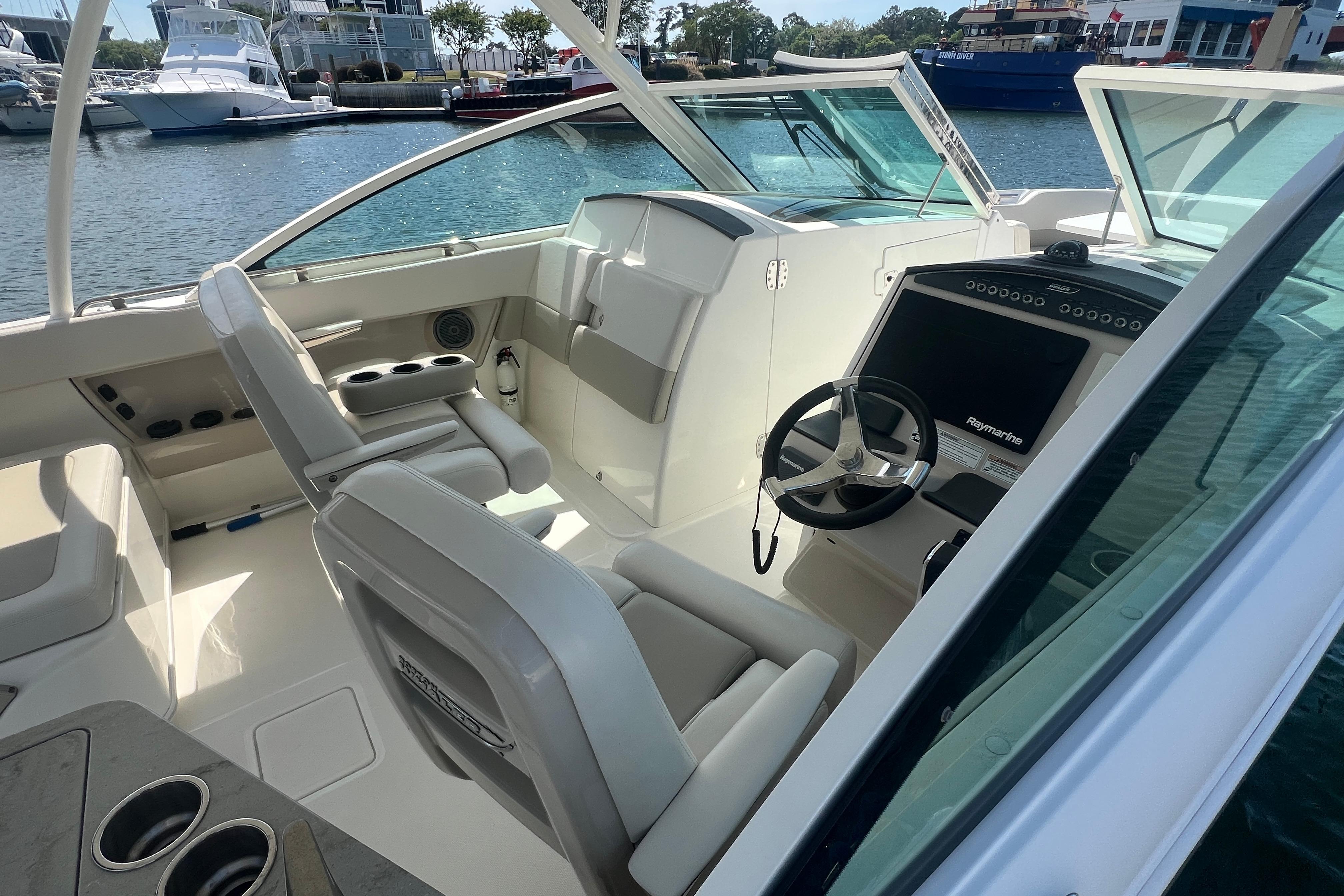 2015 Boston Whaler 320 Vantage boat interior with helm, seating, and water view.