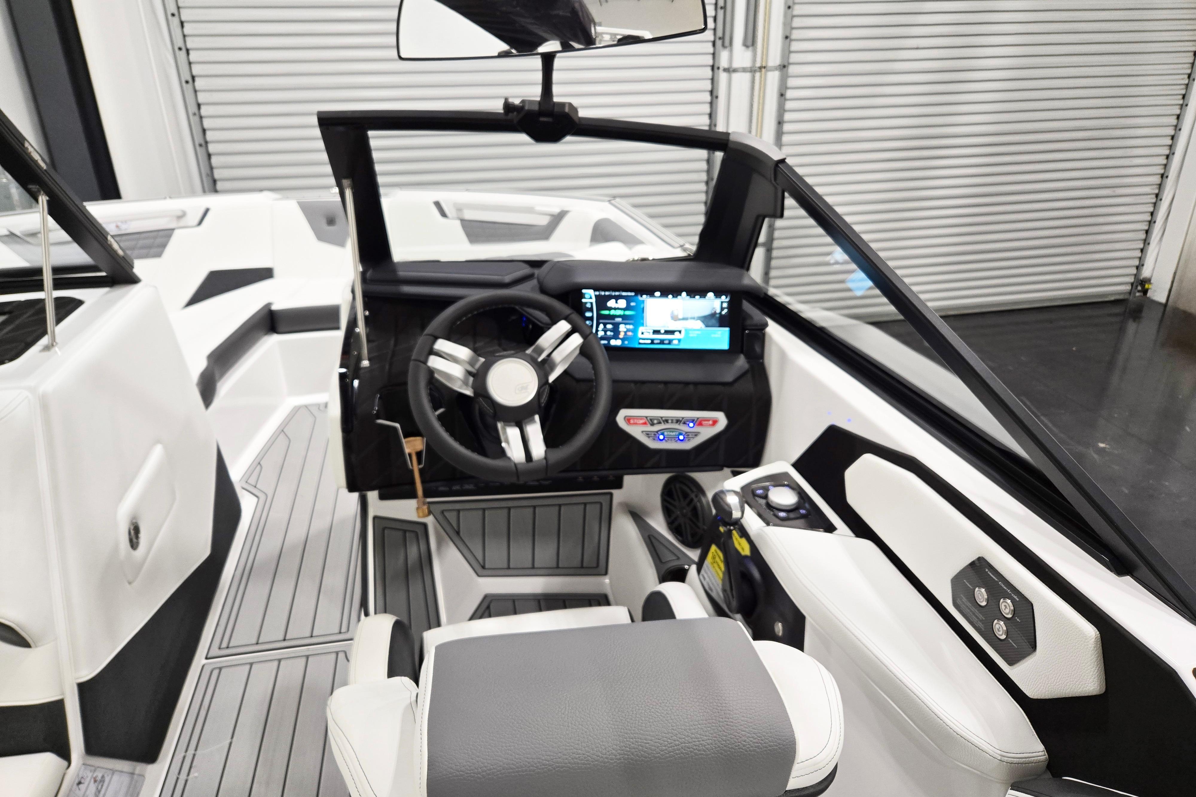 2026 Nautique Super Air Nautique S23 boat interior with modern dashboard and steering wheel.