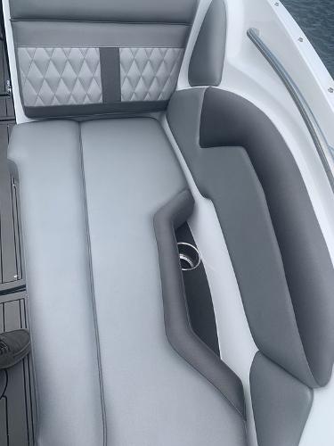 2020 Rinker 29QX BR boat interior with gray and white cushioned seating.