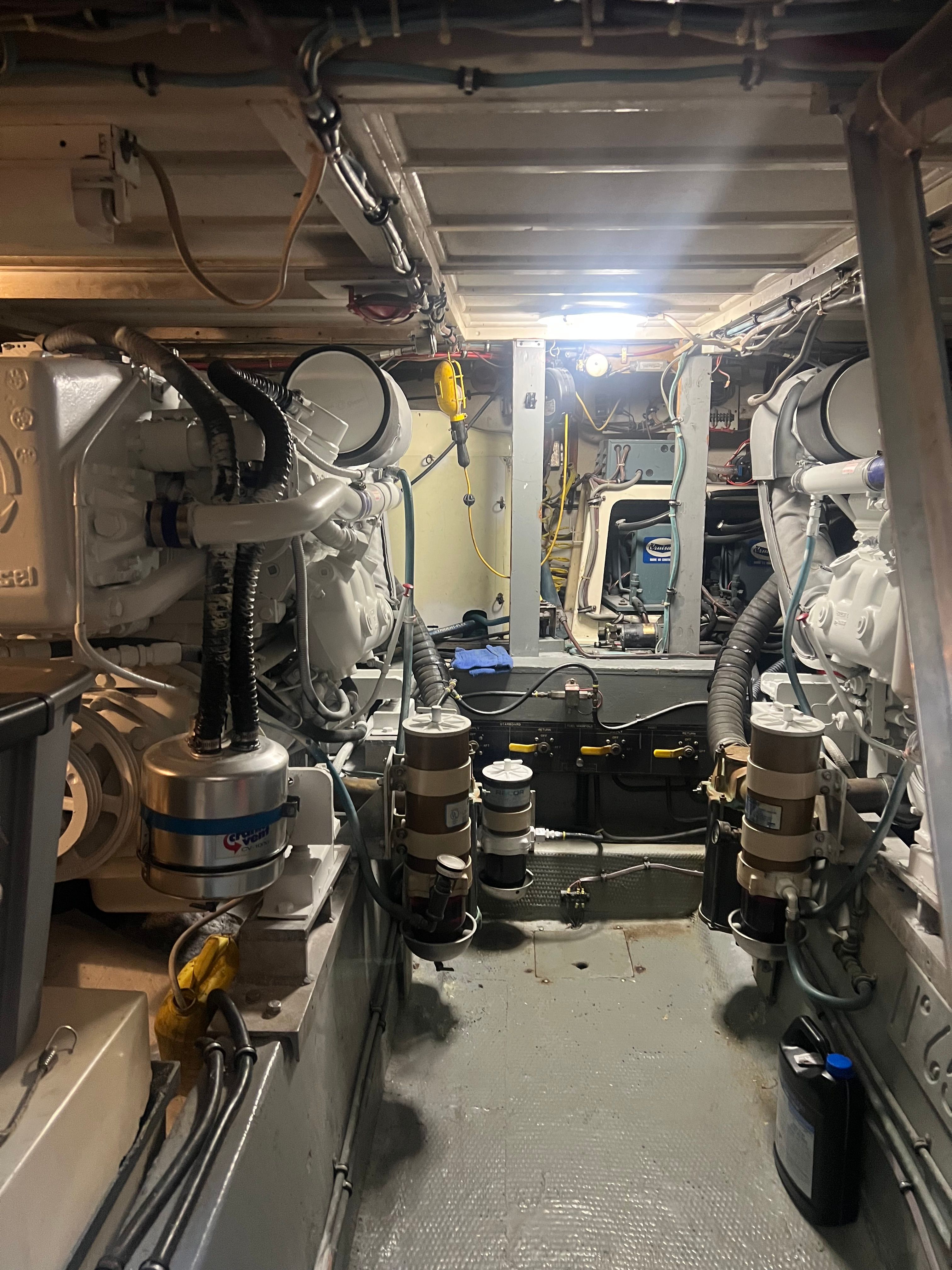 Engine room of a 1981 Hatteras Motoryacht with machinery and piping.