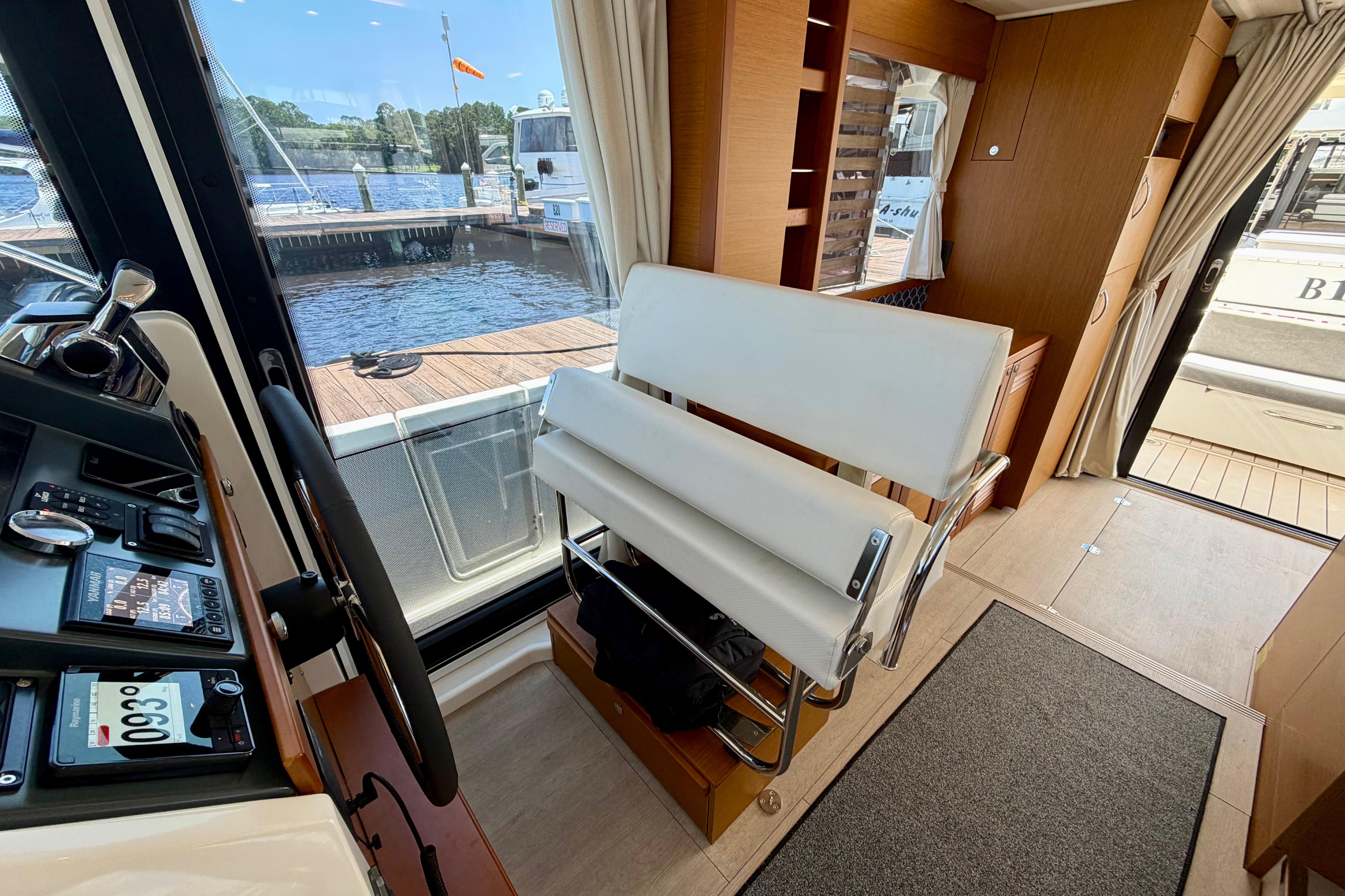 Interior view of 2025 Beneteau Swift Trawler 41 Fly, featuring helm and seating area.