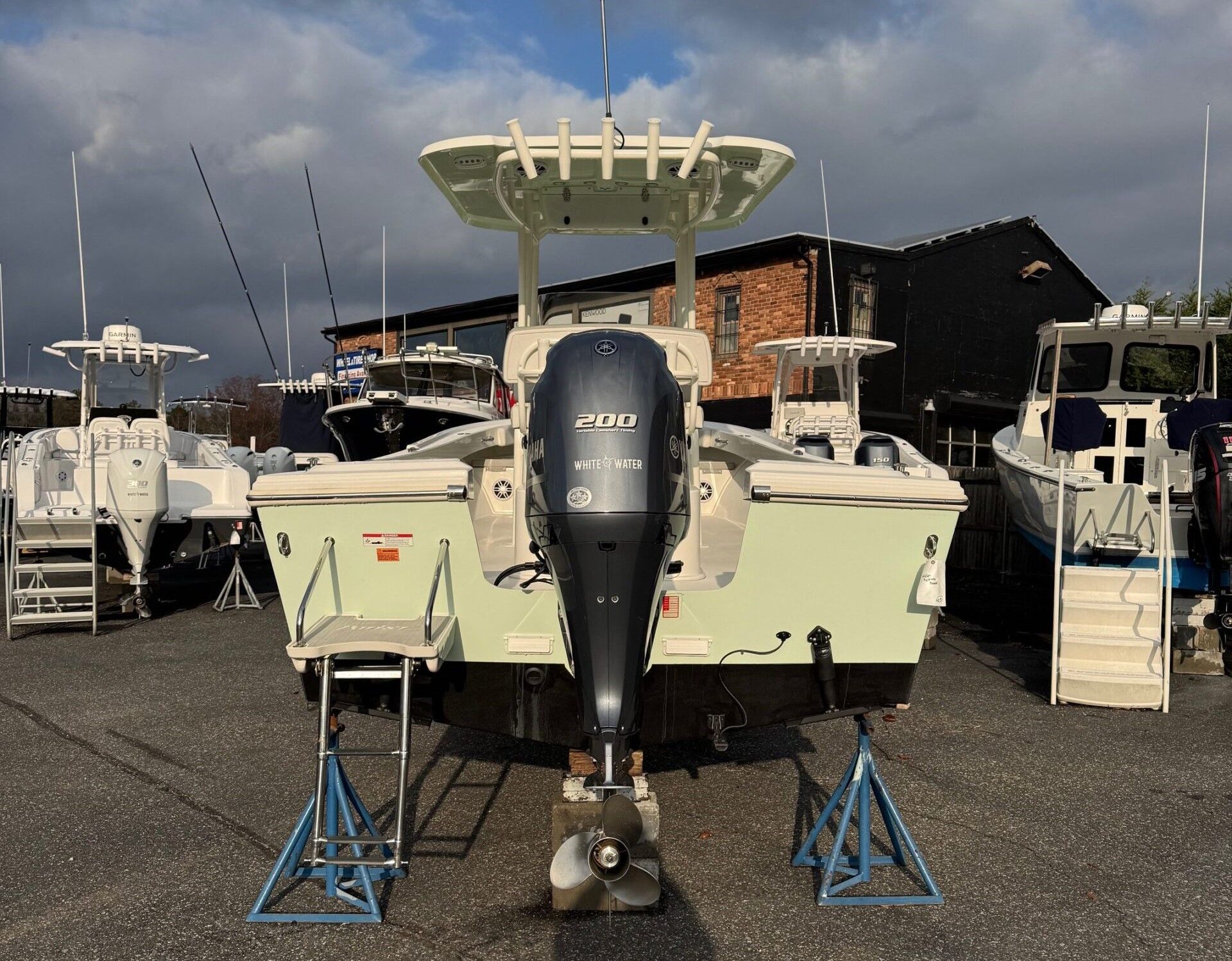 Sportsman Open 232 Center Console 2023 on a lot with other boats.