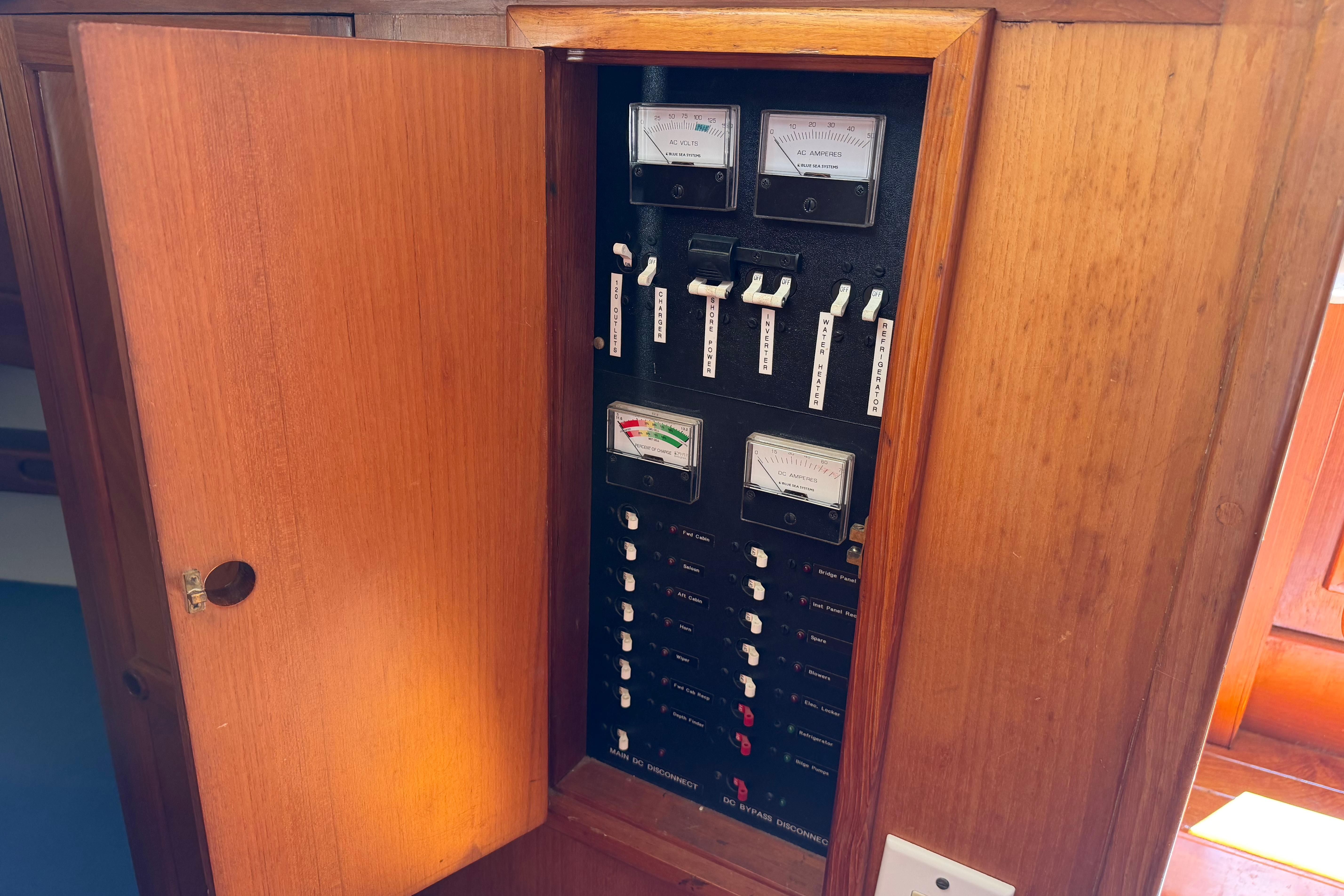 Electrical panel inside a 1987 Marine Trader 36 boat, featuring gauges and switches.