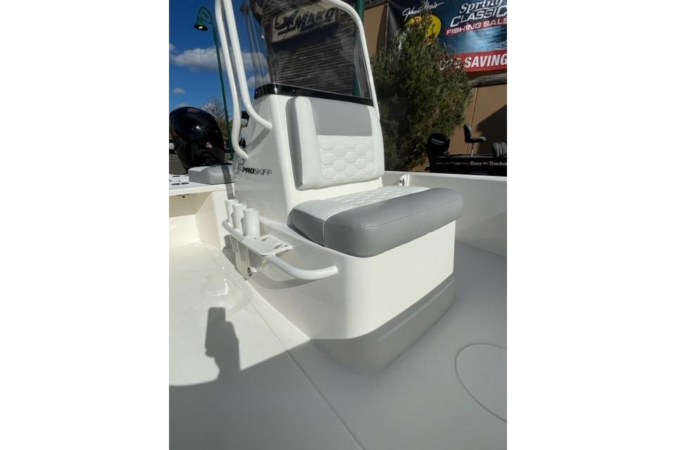 2026 Mako 18 Pro Skiff boat interior with cushioned seating and rod holders.
