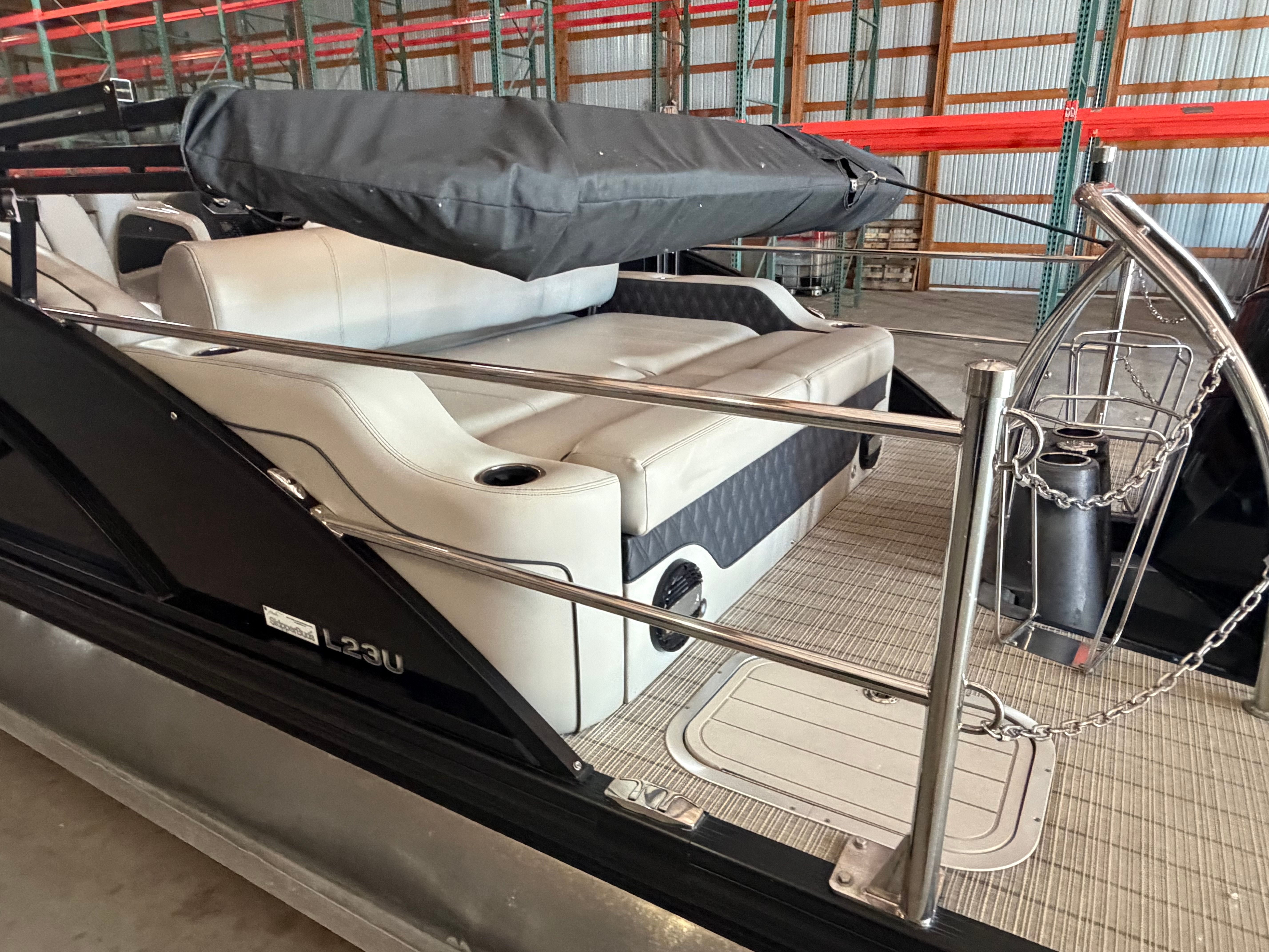 2019 Barletta L23UTT pontoon boat with seating area in warehouse.