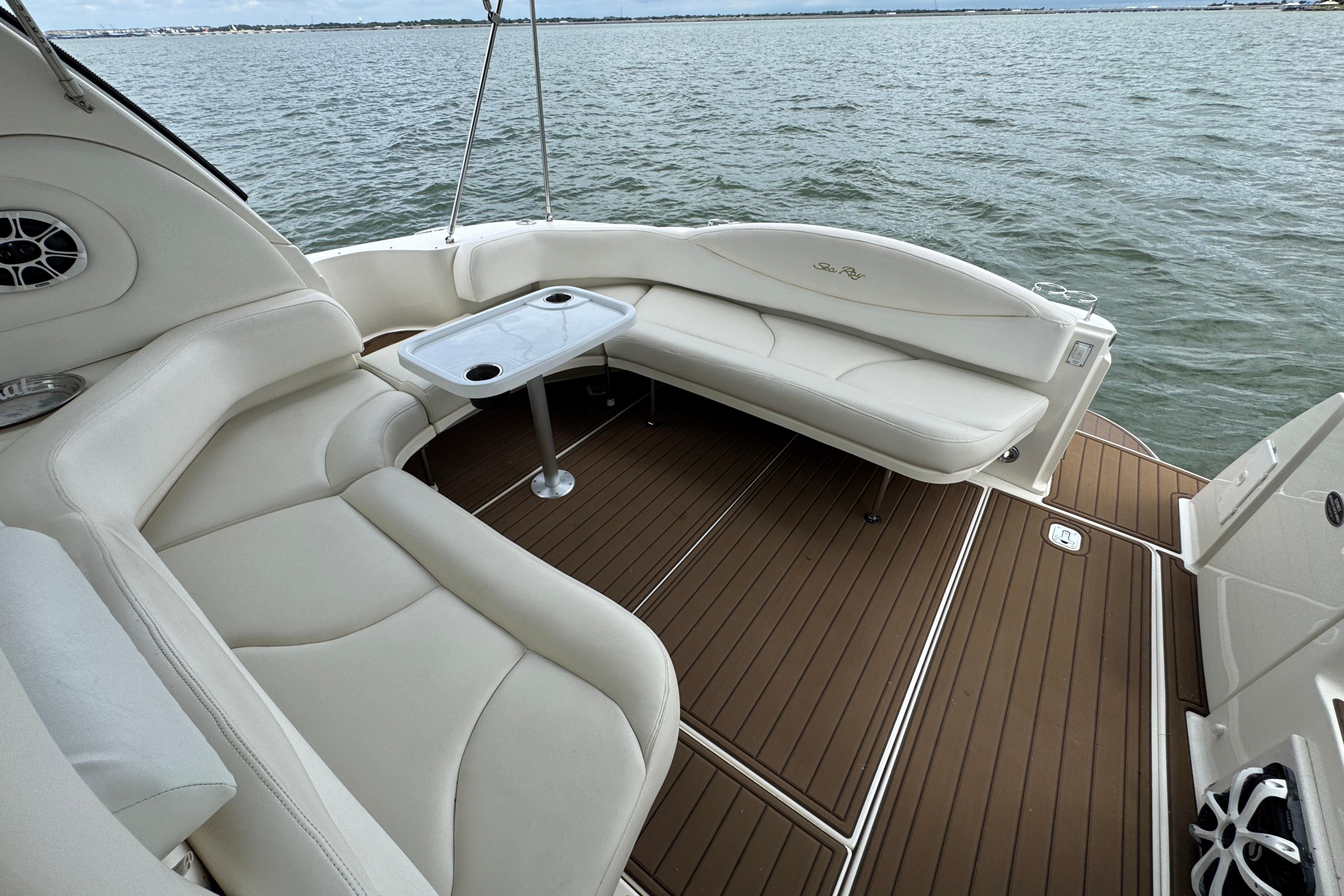 Luxurious 2001 Sea Ray 380 Sundancer boat interior with white seating and wooden deck.