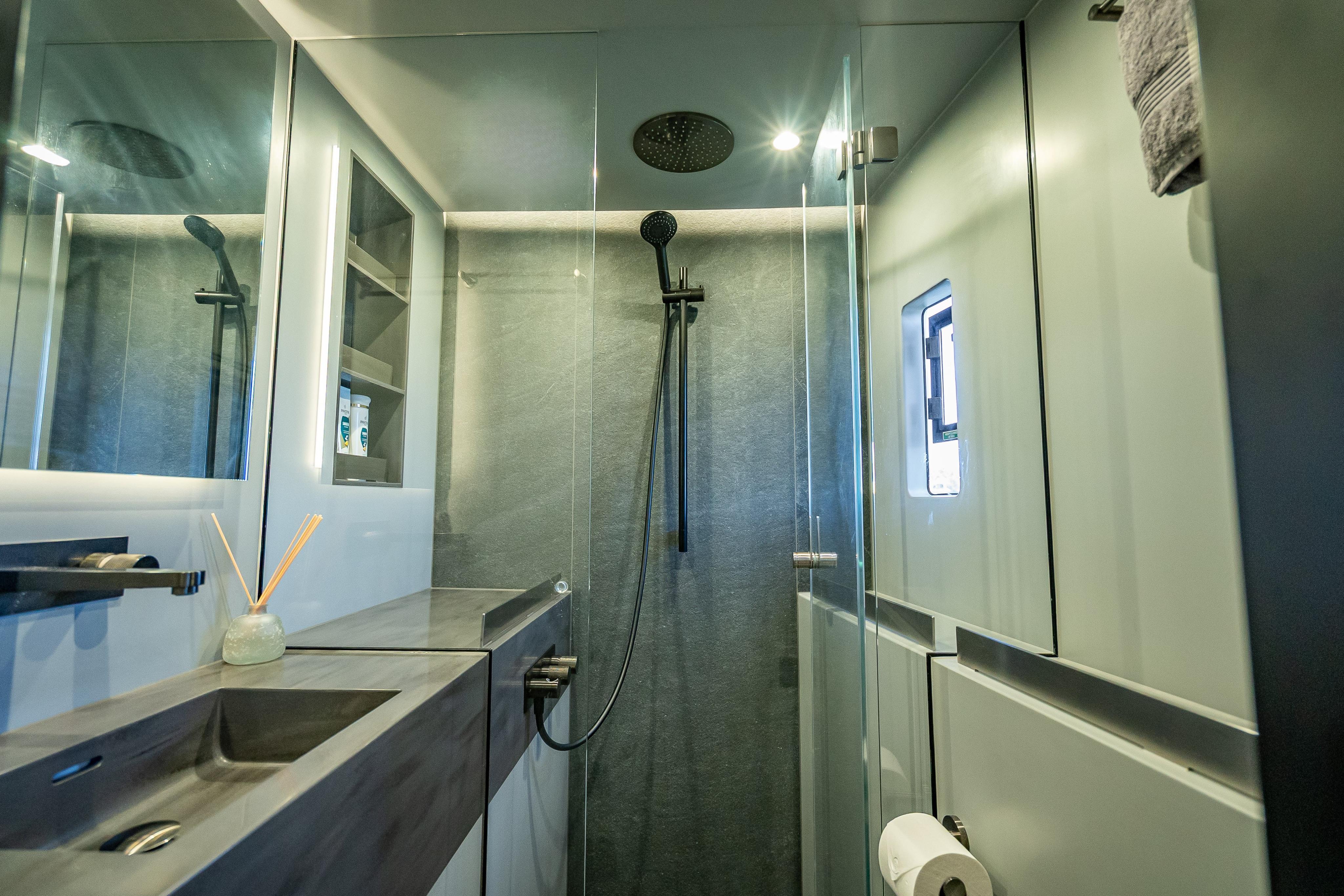 Luxurious bathroom in 2026 Sunreef 60 Power yacht, featuring modern shower and sleek design.