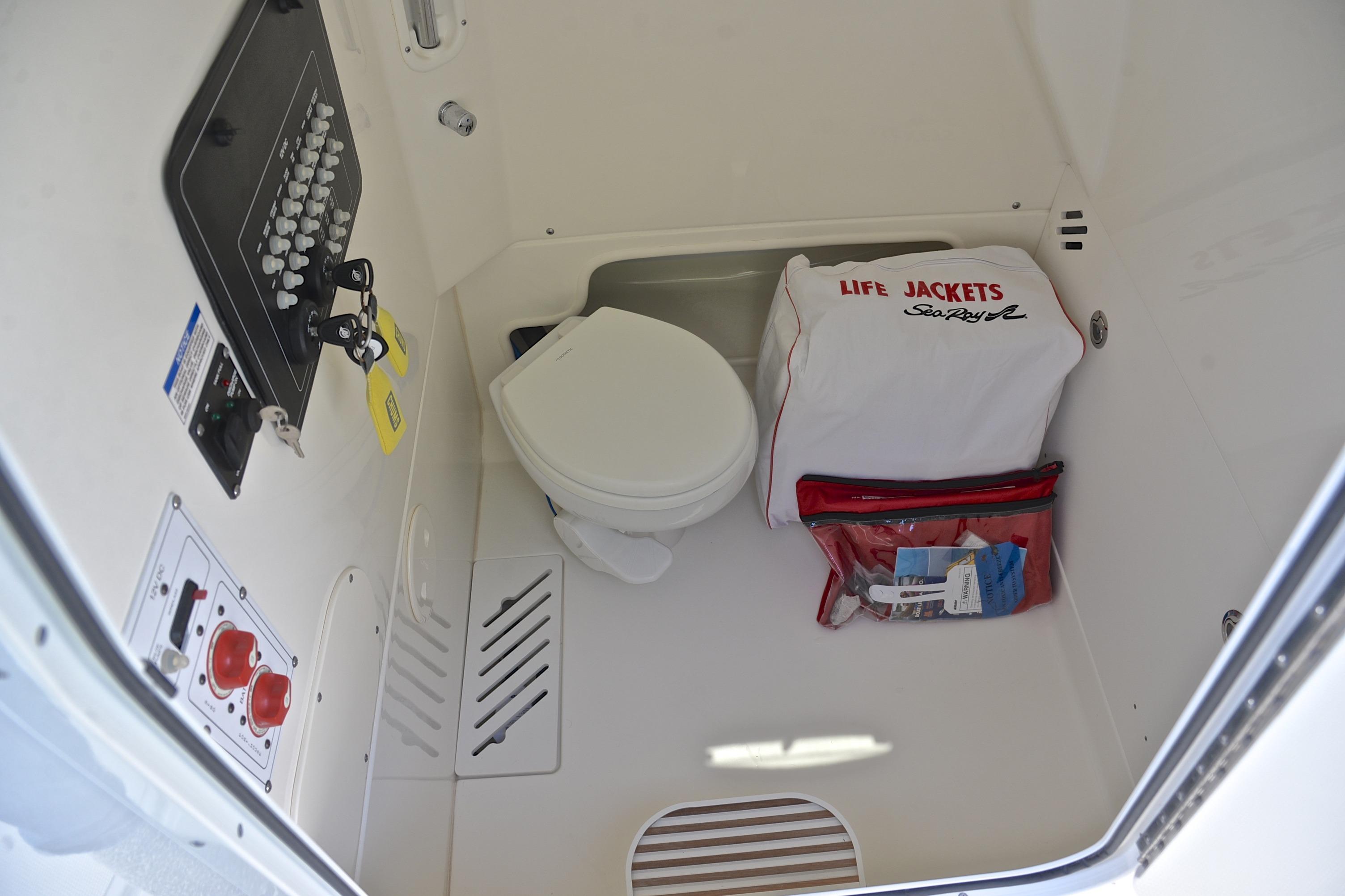 2024 Boston Whaler 250 Outrage interior with toilet and safety equipment.