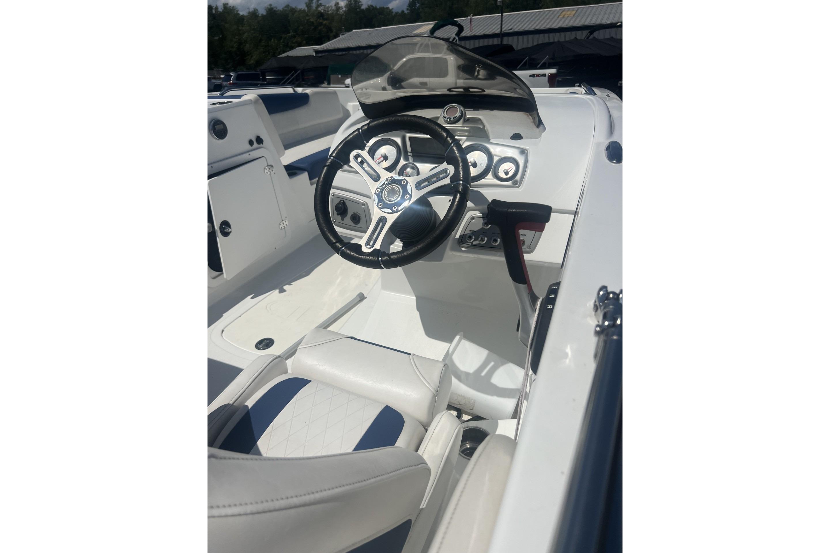 2017 Tahoe 2150 boat cockpit with steering wheel and dashboard controls.
