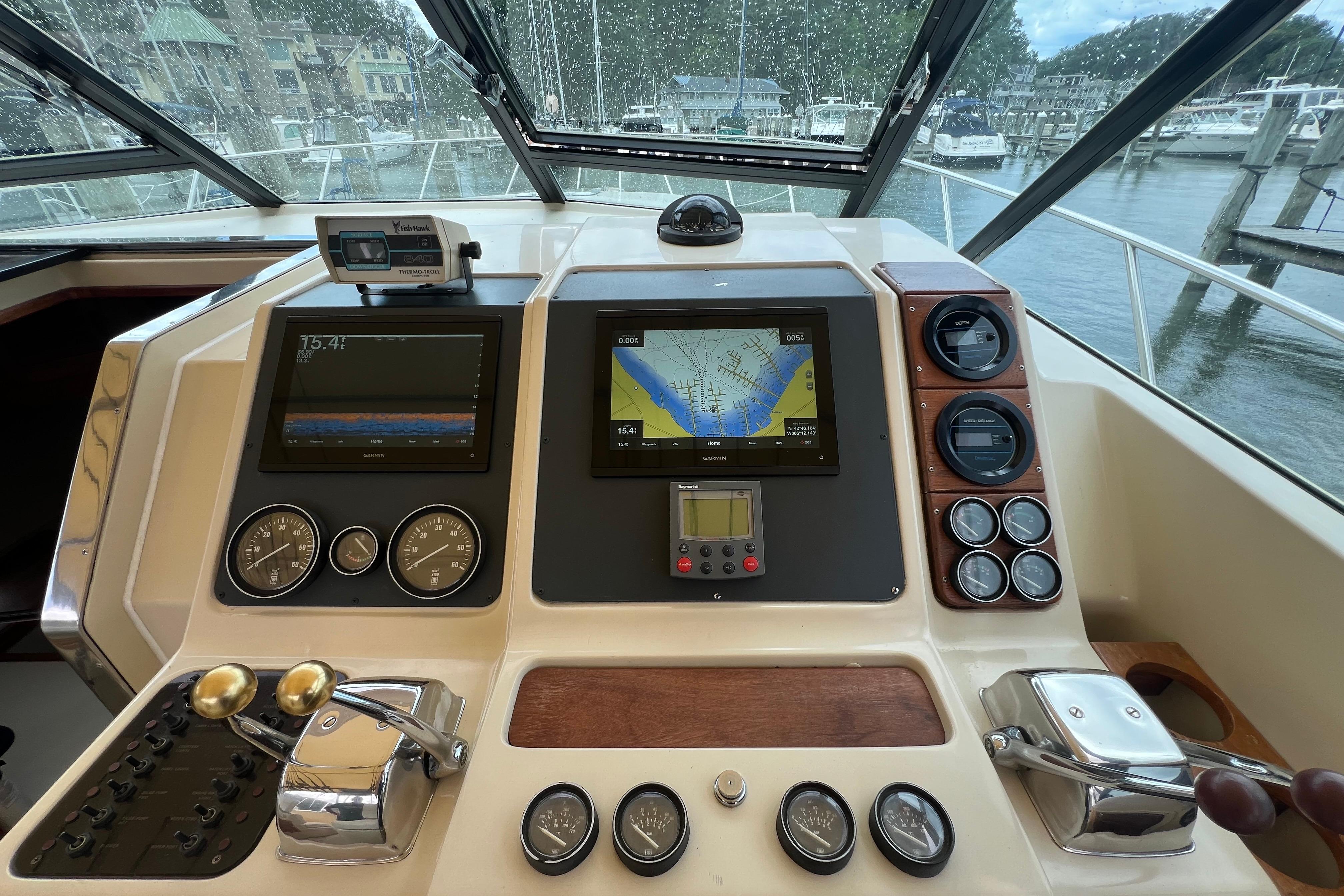 Cockpit of 1985 Tiara 36 OPEN boat with navigation instruments and controls.