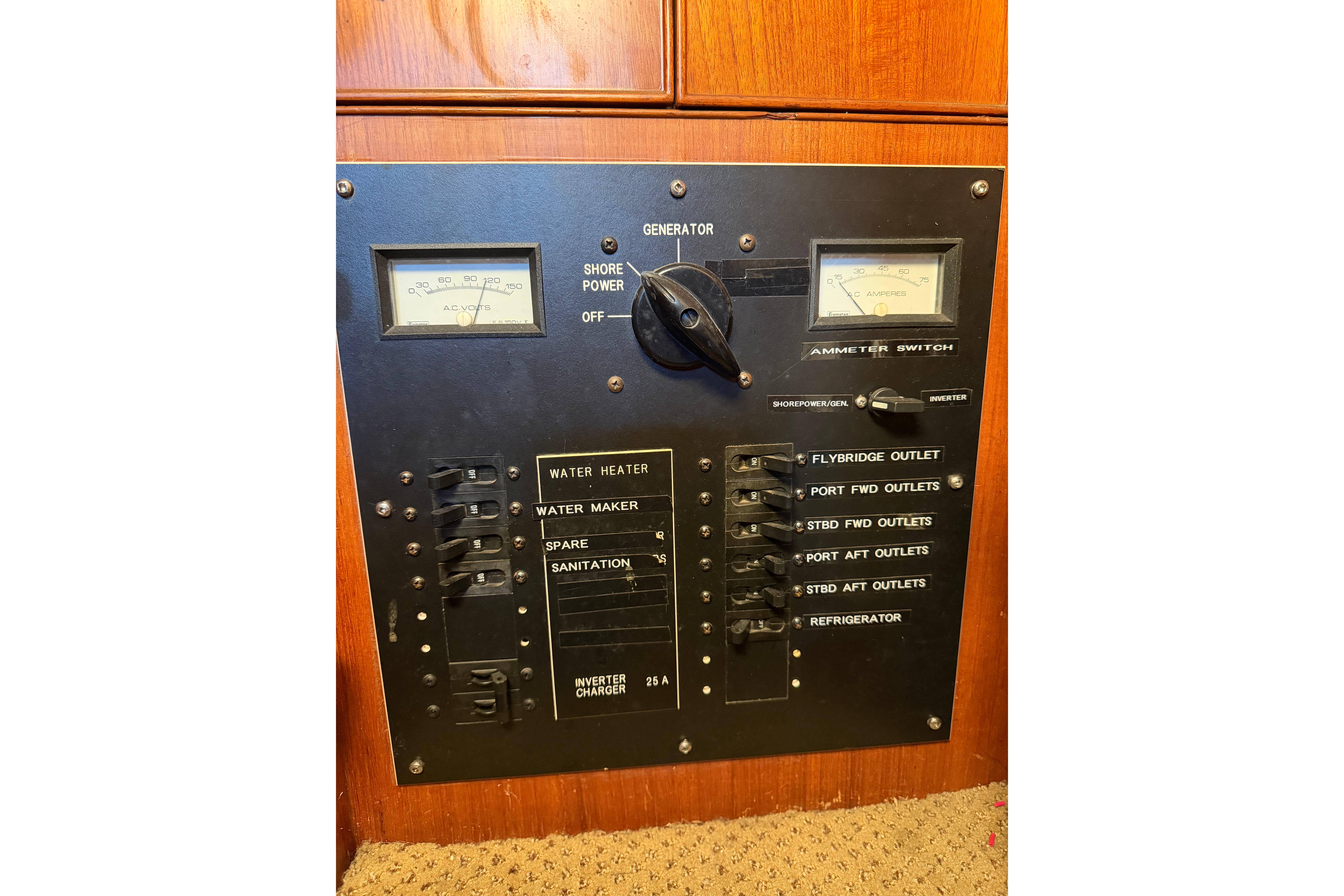 Electrical panel of a 1969 Grand Banks 42 Classic boat, featuring switches and gauges.