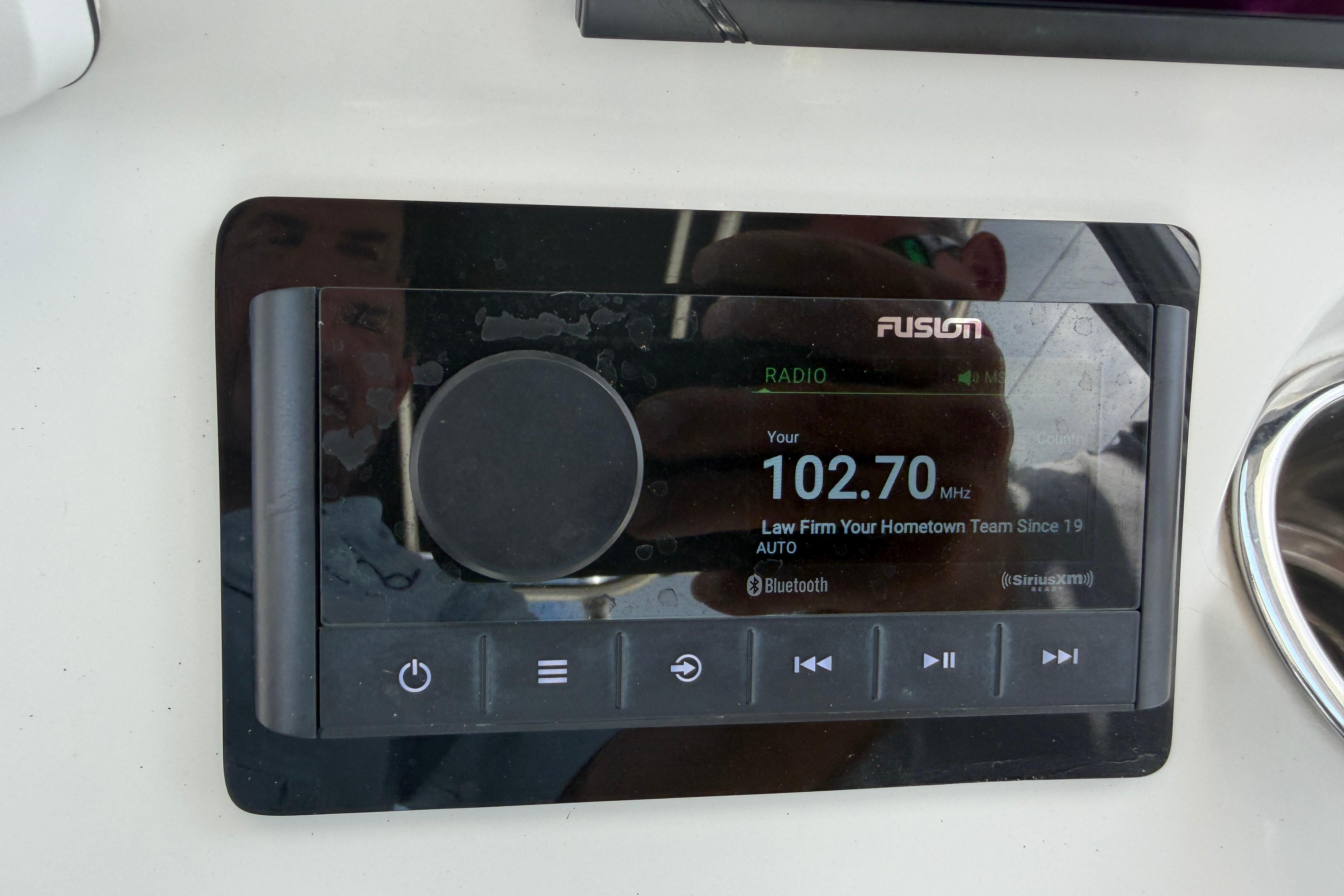Fusion radio display on 2015 Sea Hunt Triton 225 boat dashboard.