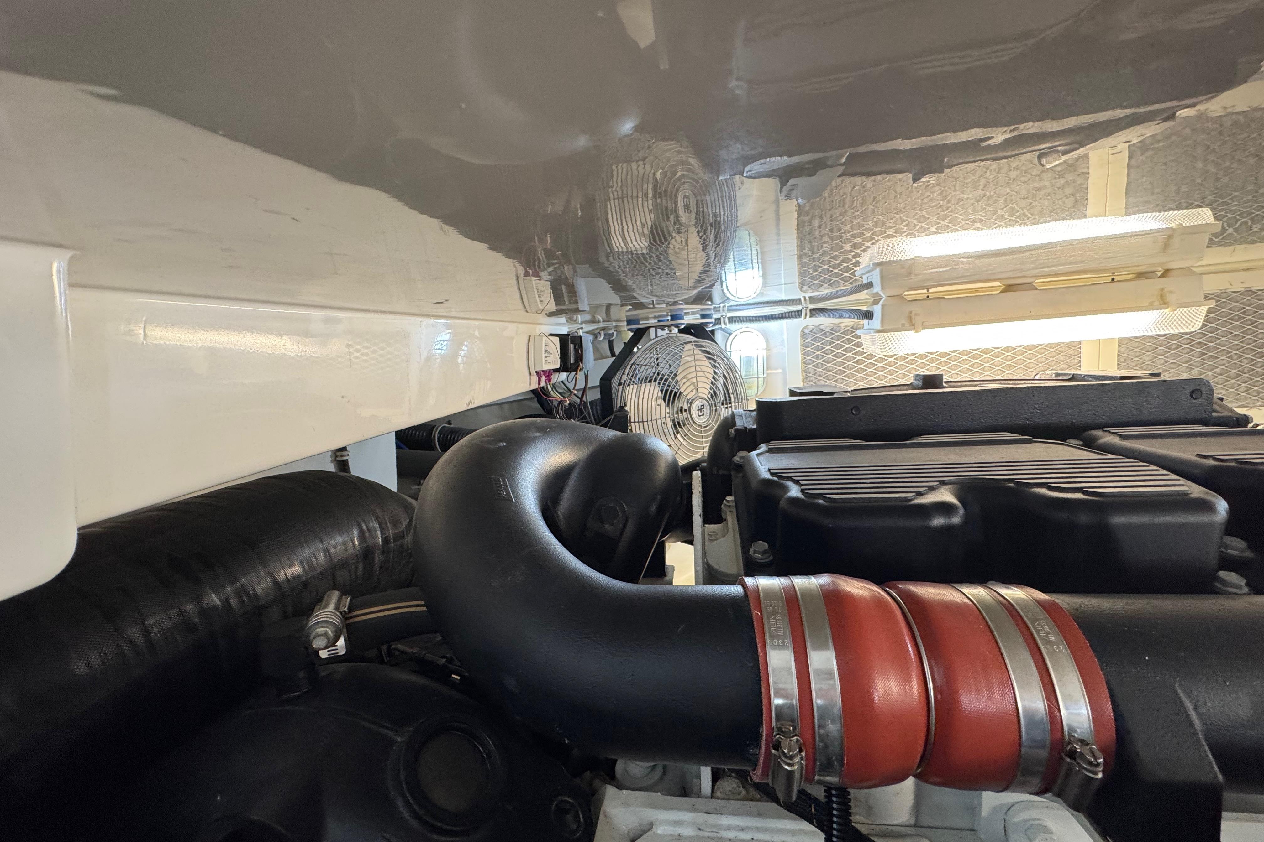 Engine room of 2013 Cabo 44 Hardtop Express with visible components and ventilation system.
