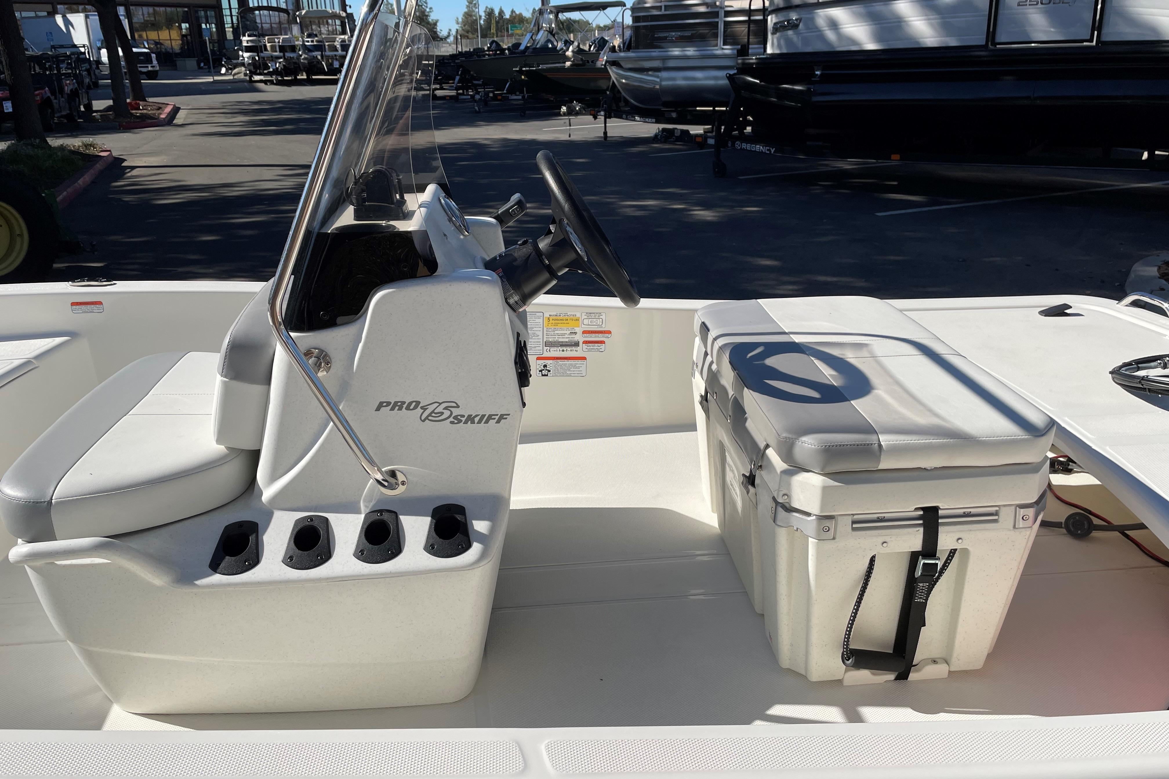 2025 Mako Pro Skiff 15 CC boat interior with console and cooler.