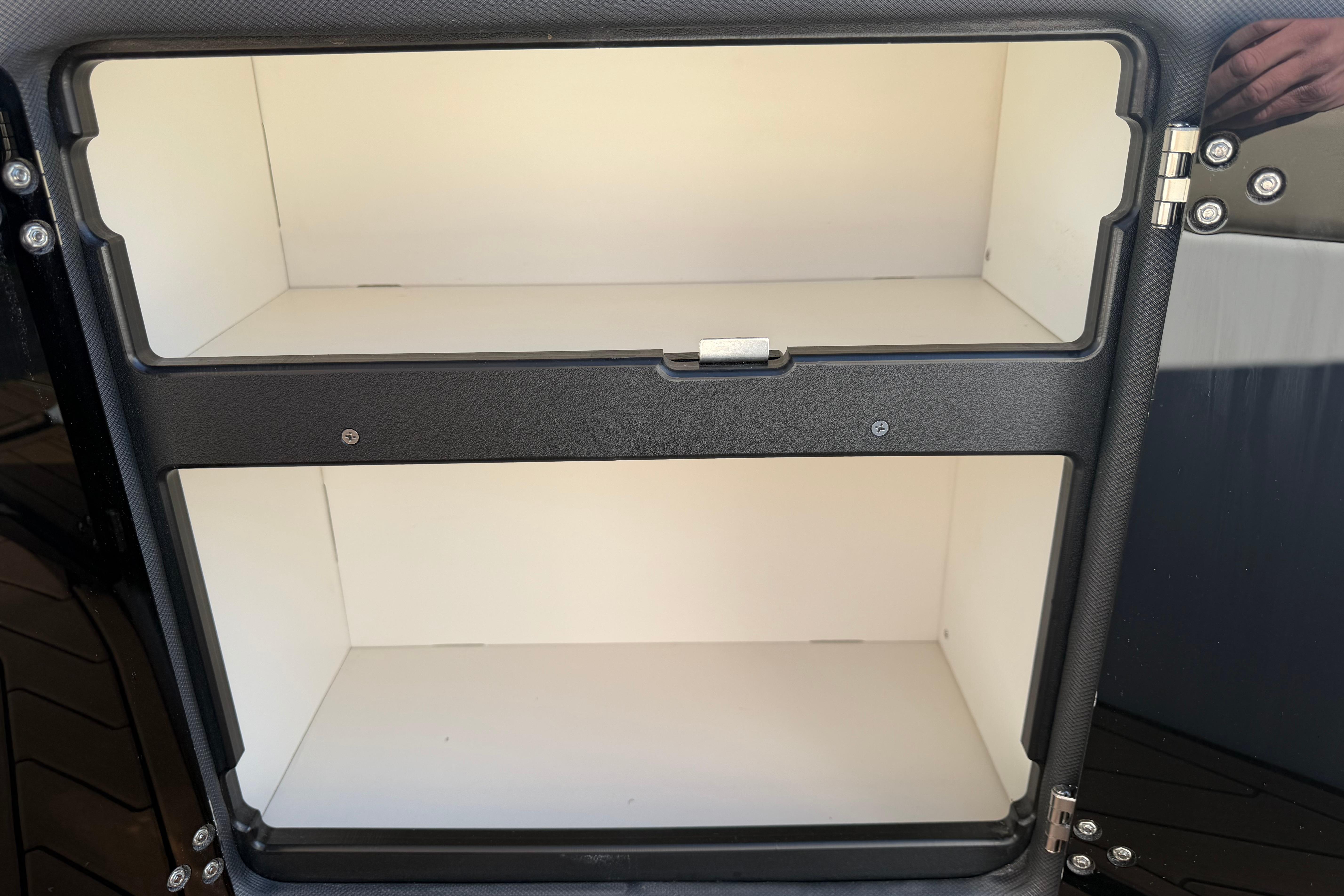 2019 Rinker EX 320 storage compartment with open shelves and secure latch.