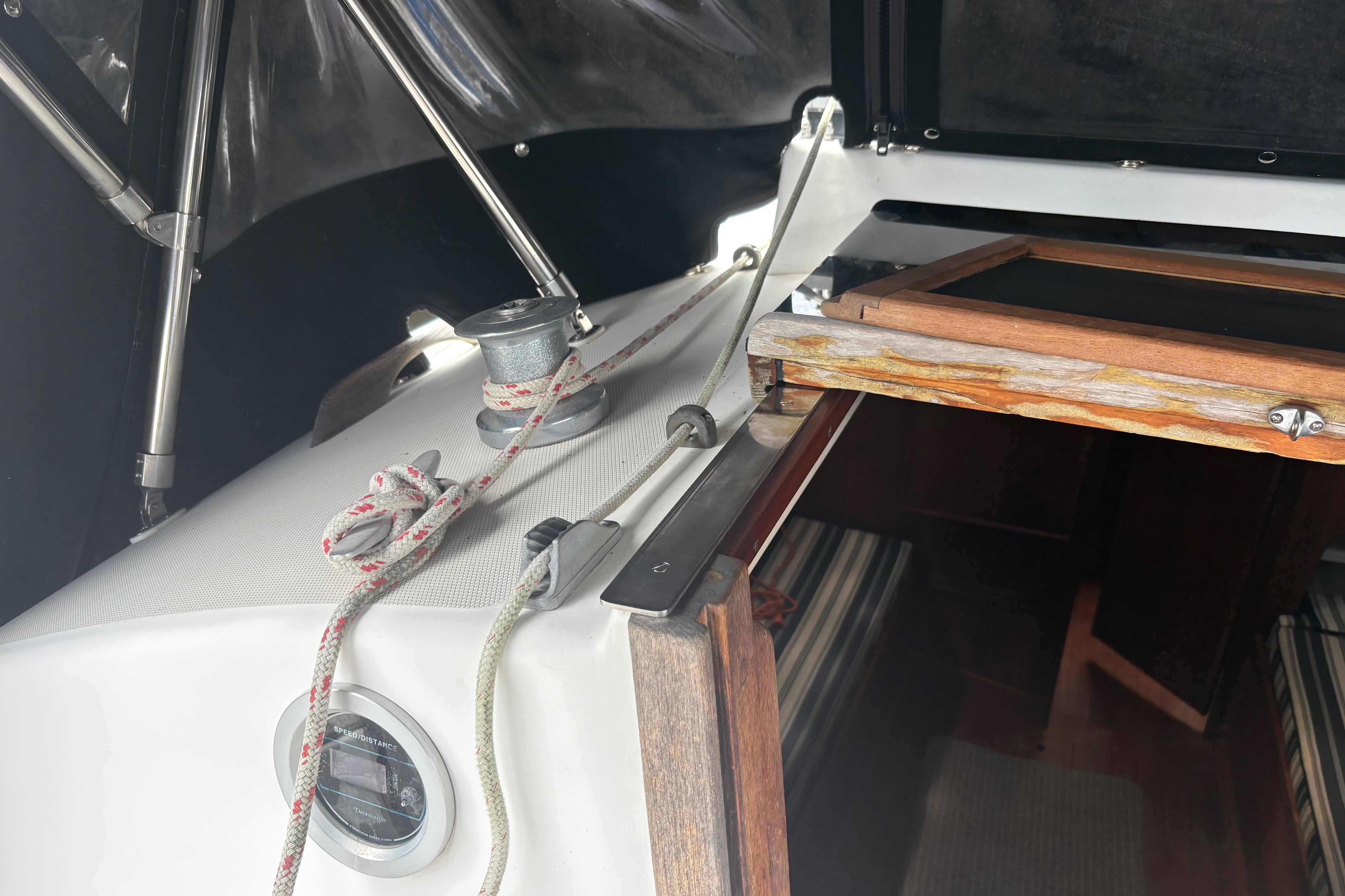 Interior view of a 1981 Sabre 31 sailboat with ropes and wooden hatch.