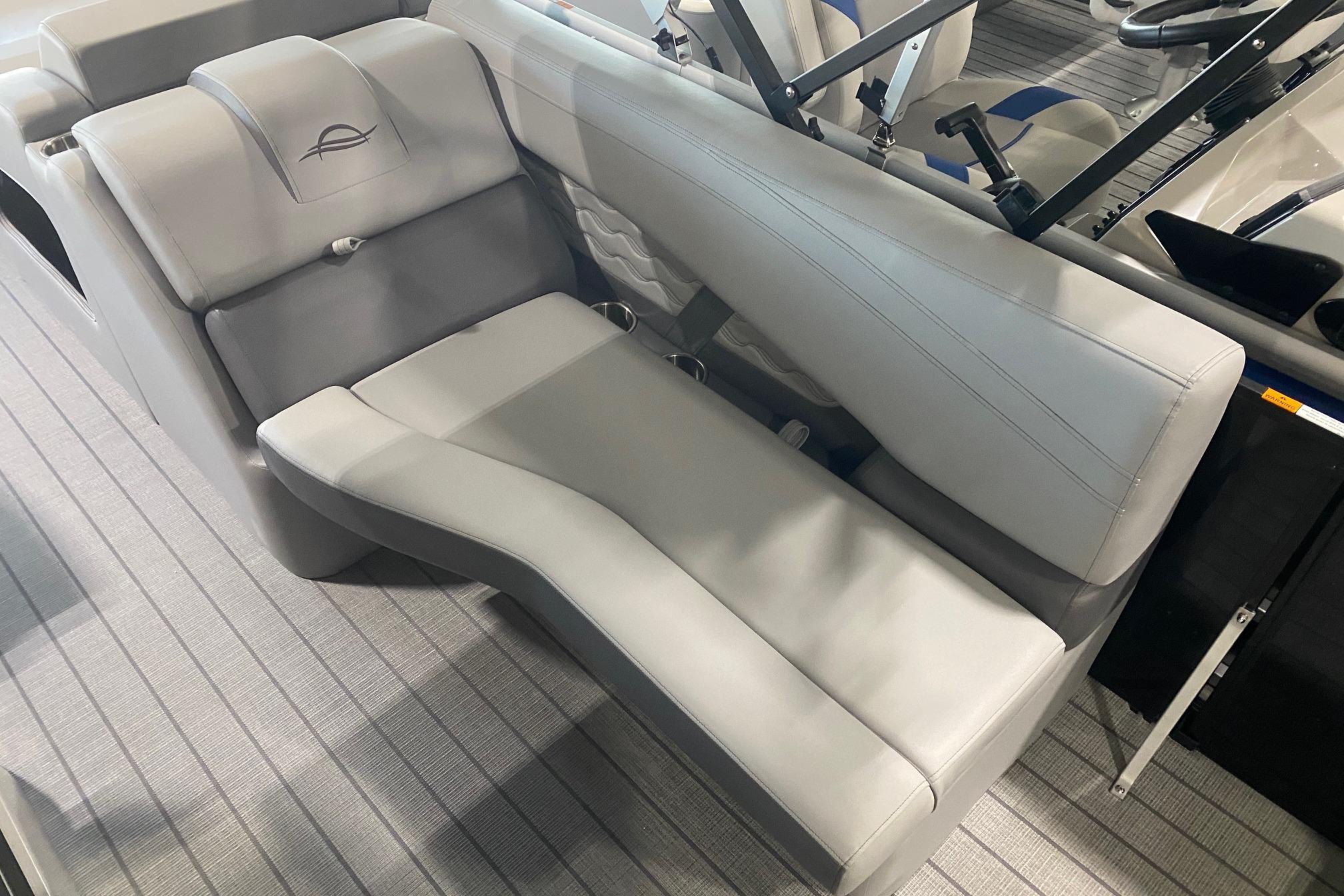 Luxurious seating in 2026 SunCatcher Fusion 324SS boat, featuring sleek gray upholstery.