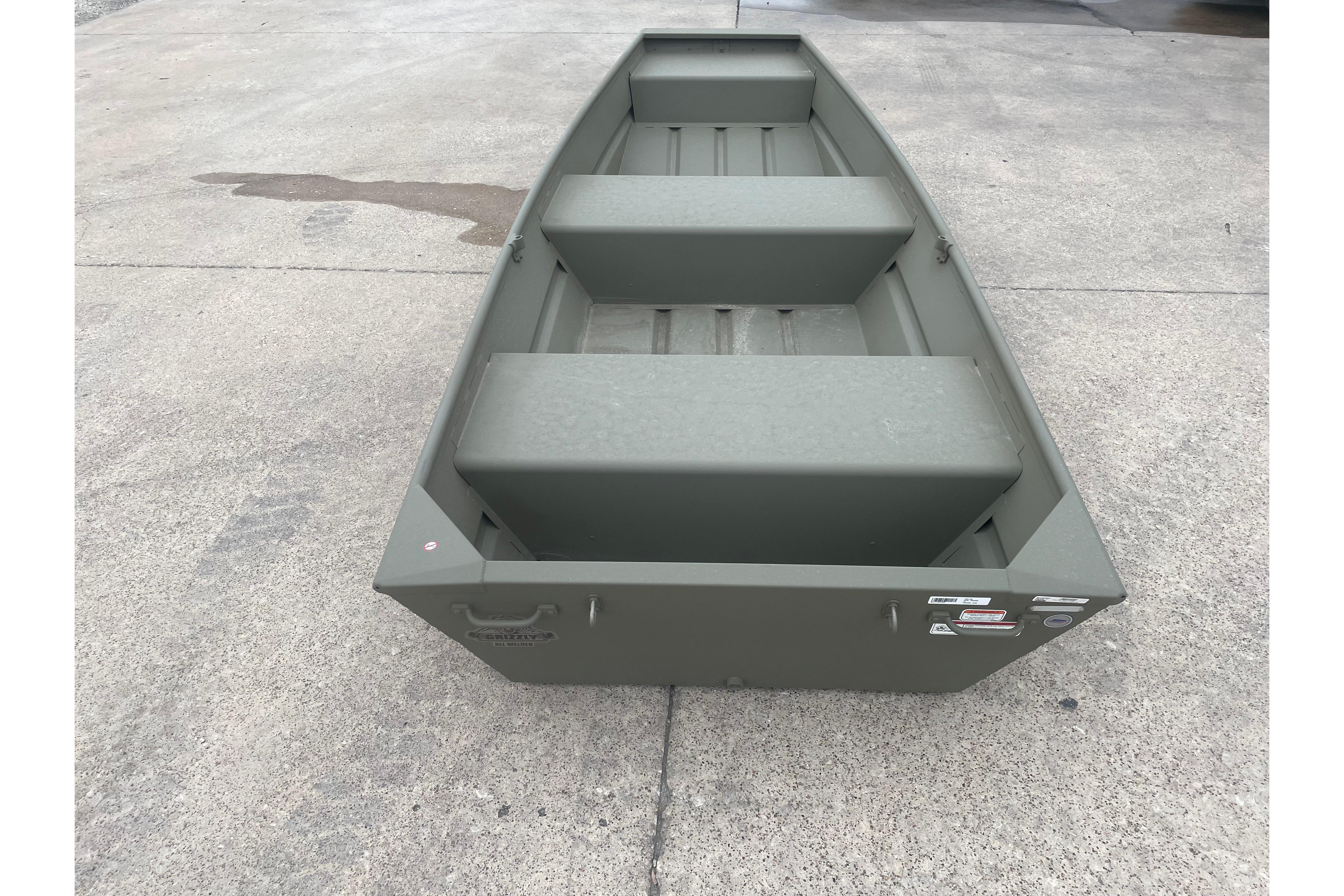 2026 Tracker Grizzly 12 Jon boat on concrete surface, showcasing its sturdy design.