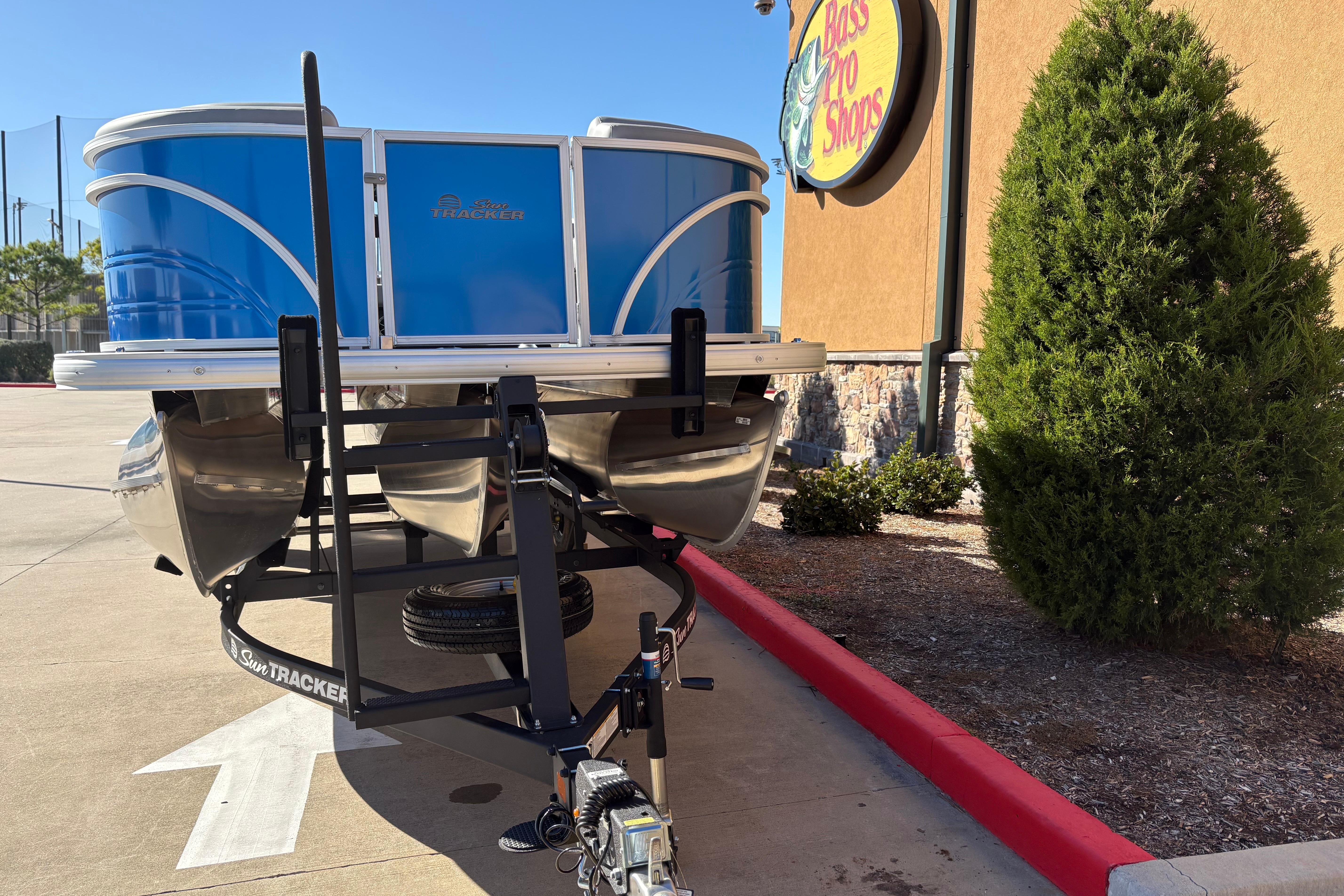 2026 Sun Tracker Party Barge 22 RF XP3 on trailer outside Bass Pro Shops.