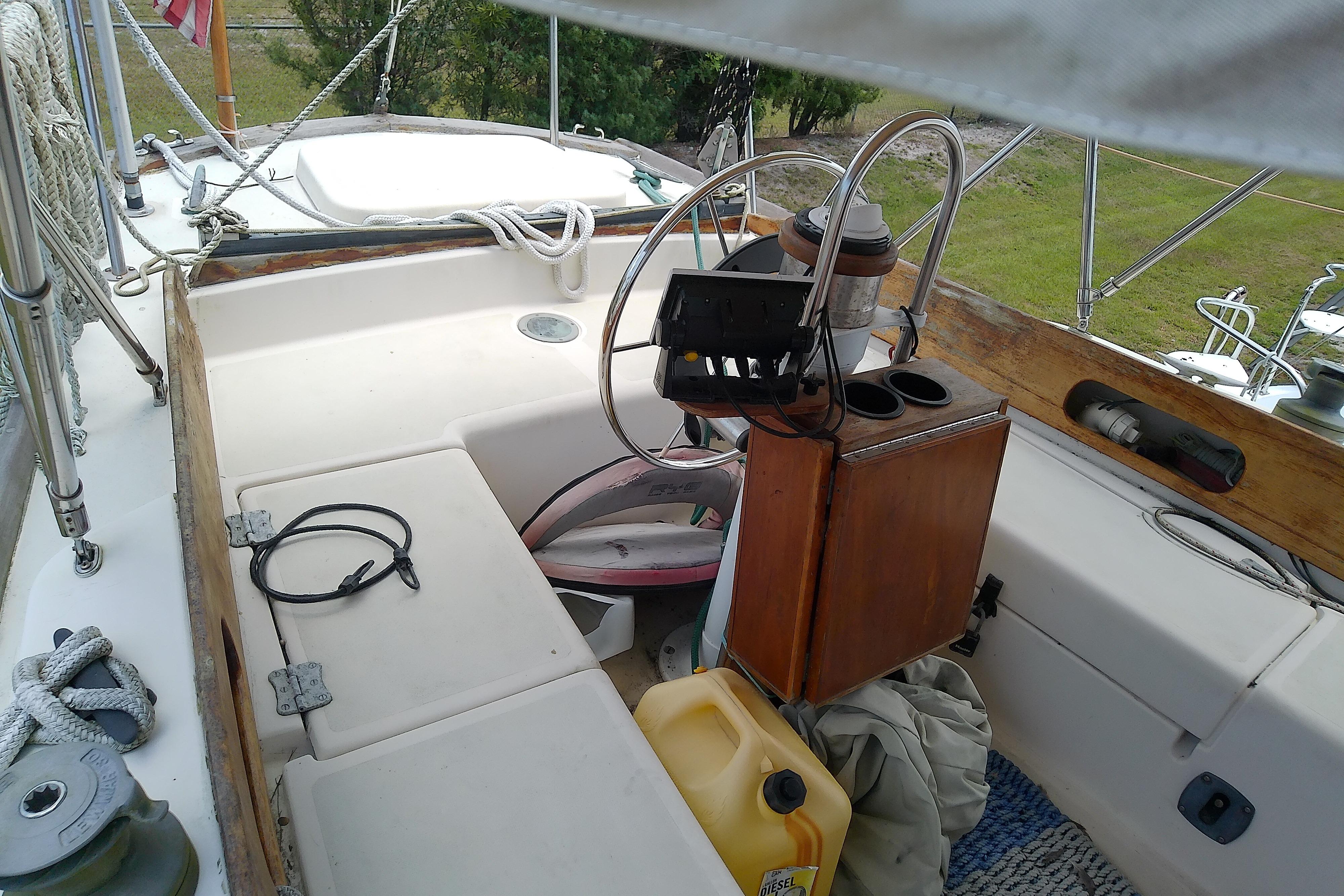 Cockpit of 1981 Sea Sprite 34 sailboat with steering wheel and nautical equipment.