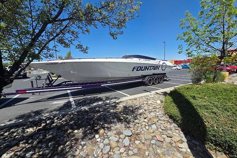 2004 Fountain 38 Lightning boat on trailer in parking lot, sunny day.