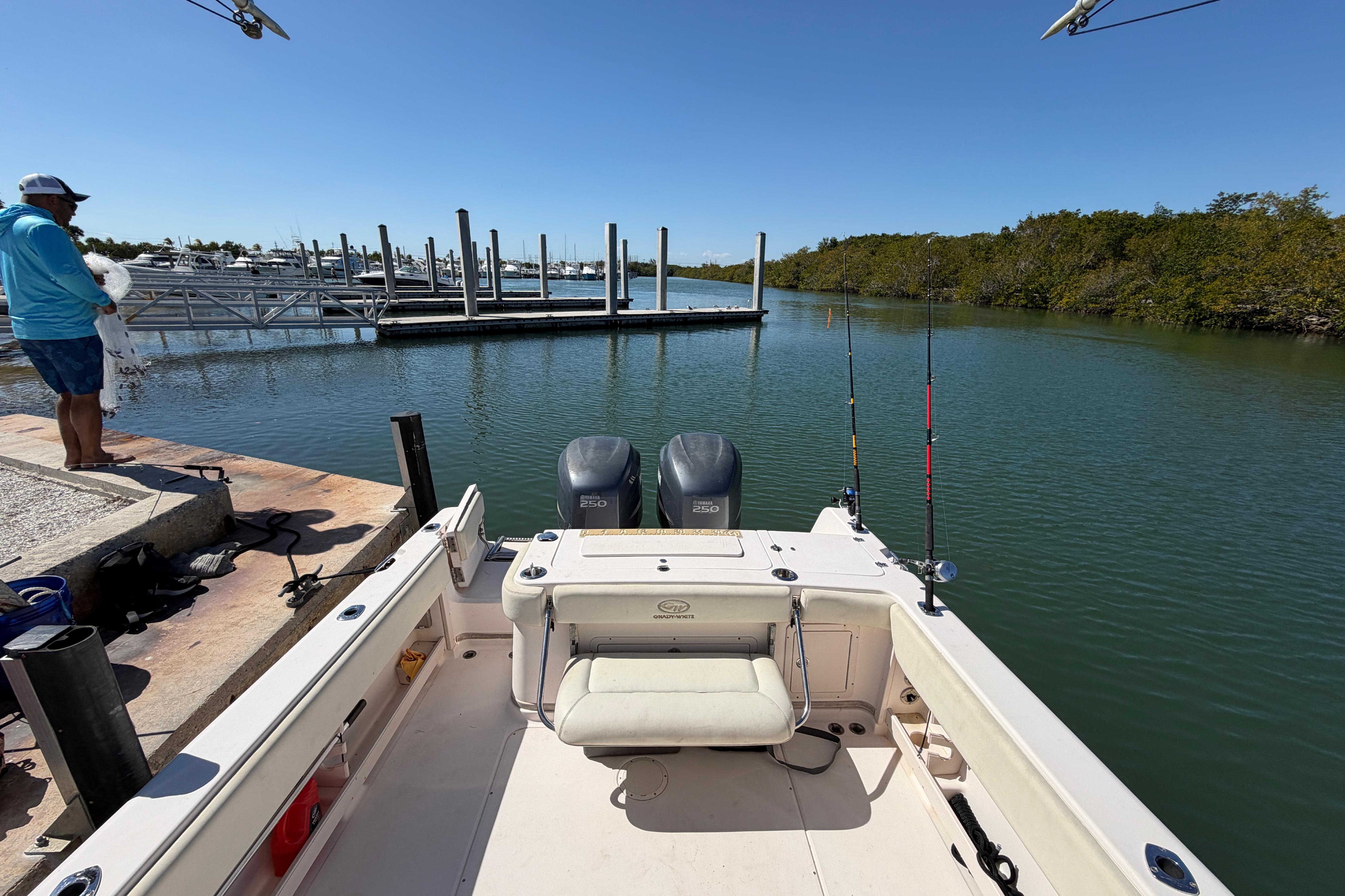 2006 Grady-White Sailfish 282 at dock, fishing rods ready, calm waters, clear sky.