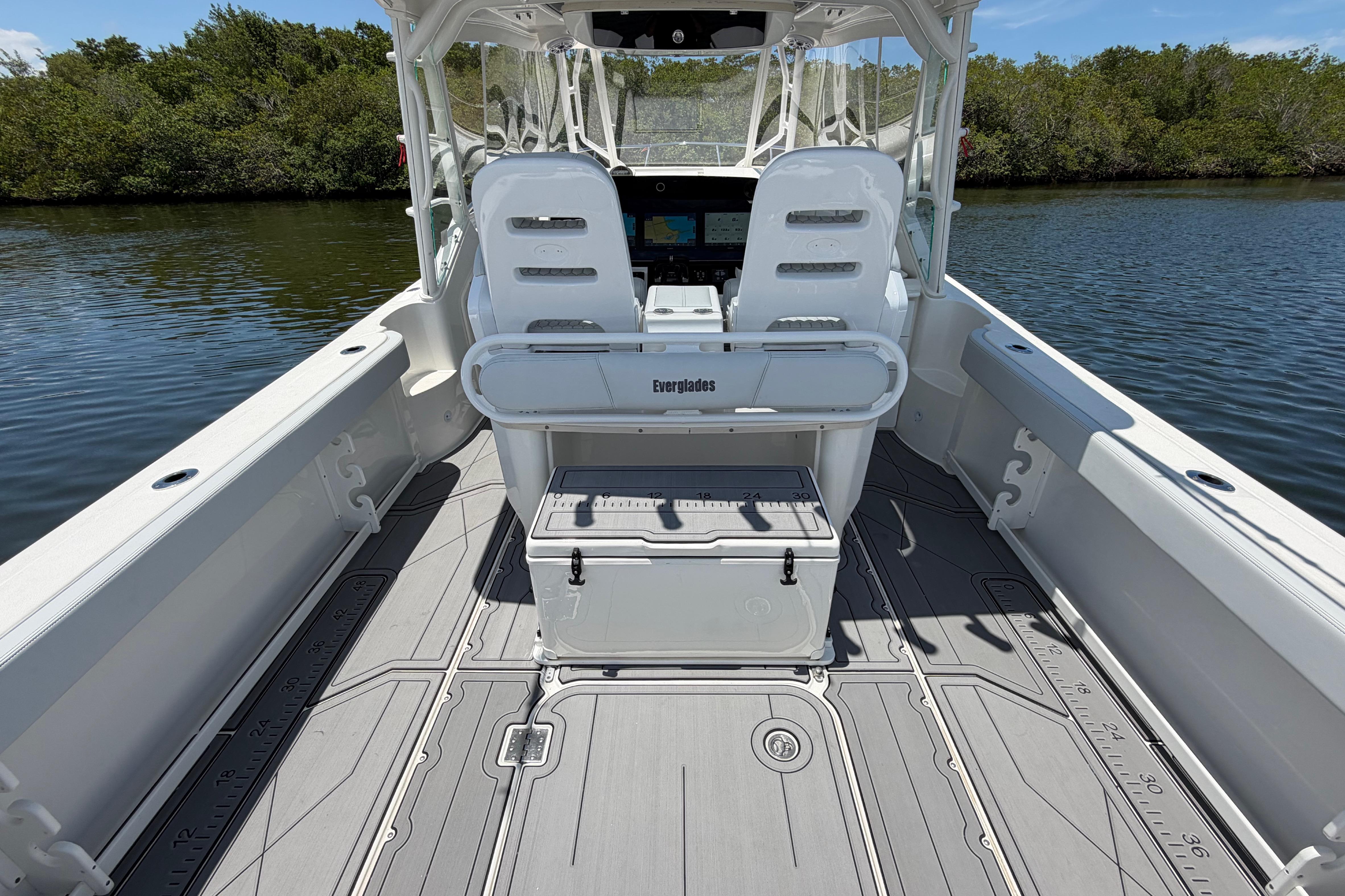 2009 Everglades 350LX boat interior with seating and storage, on calm water.