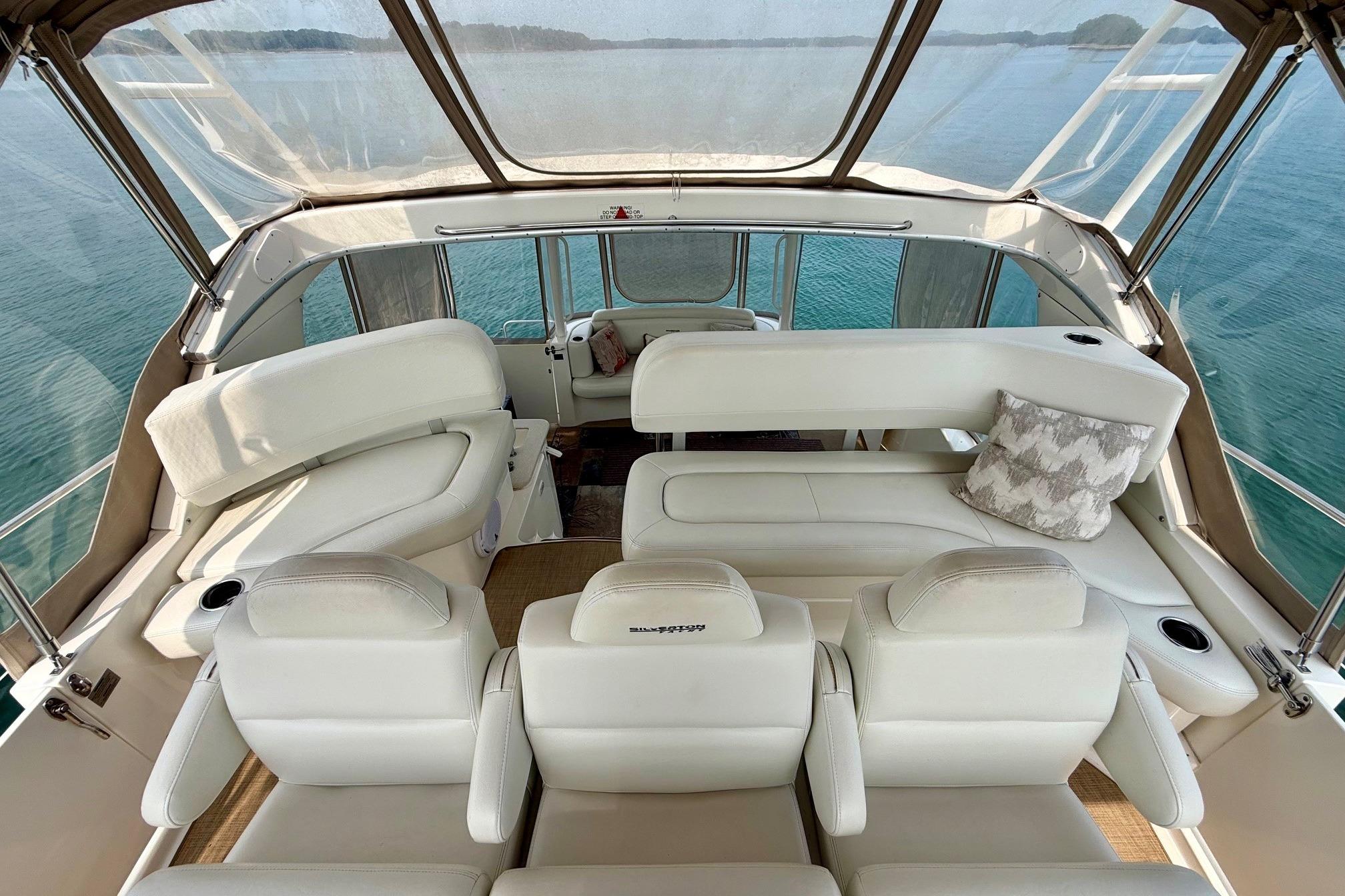 Luxurious interior of 2004 Silverton 39 Motor Yacht with plush seating and scenic ocean view.