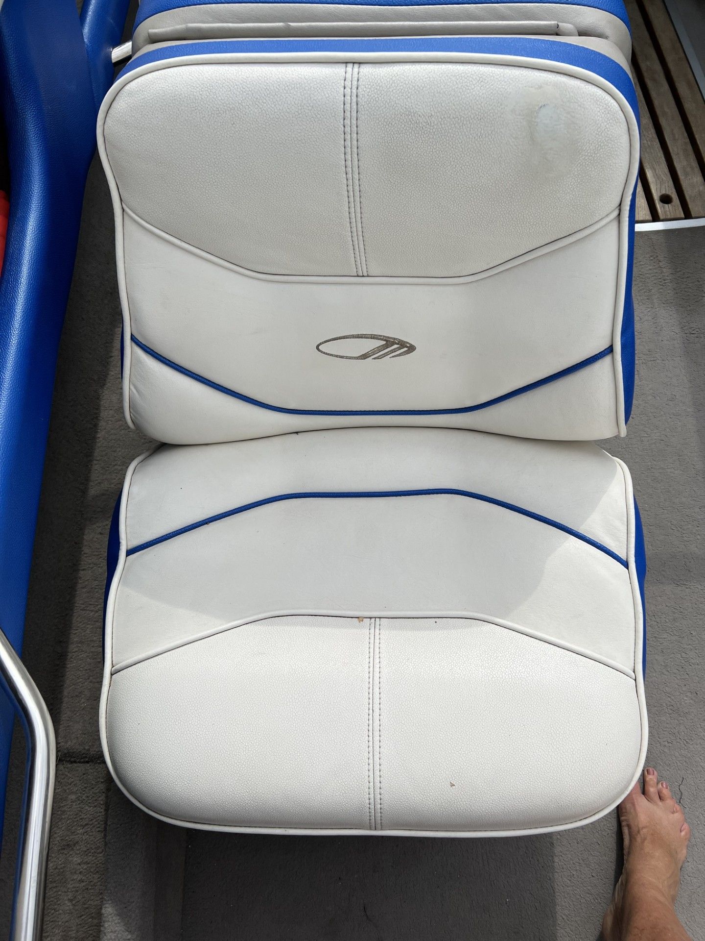 White and blue boat seats with an embroidered logo in the center.