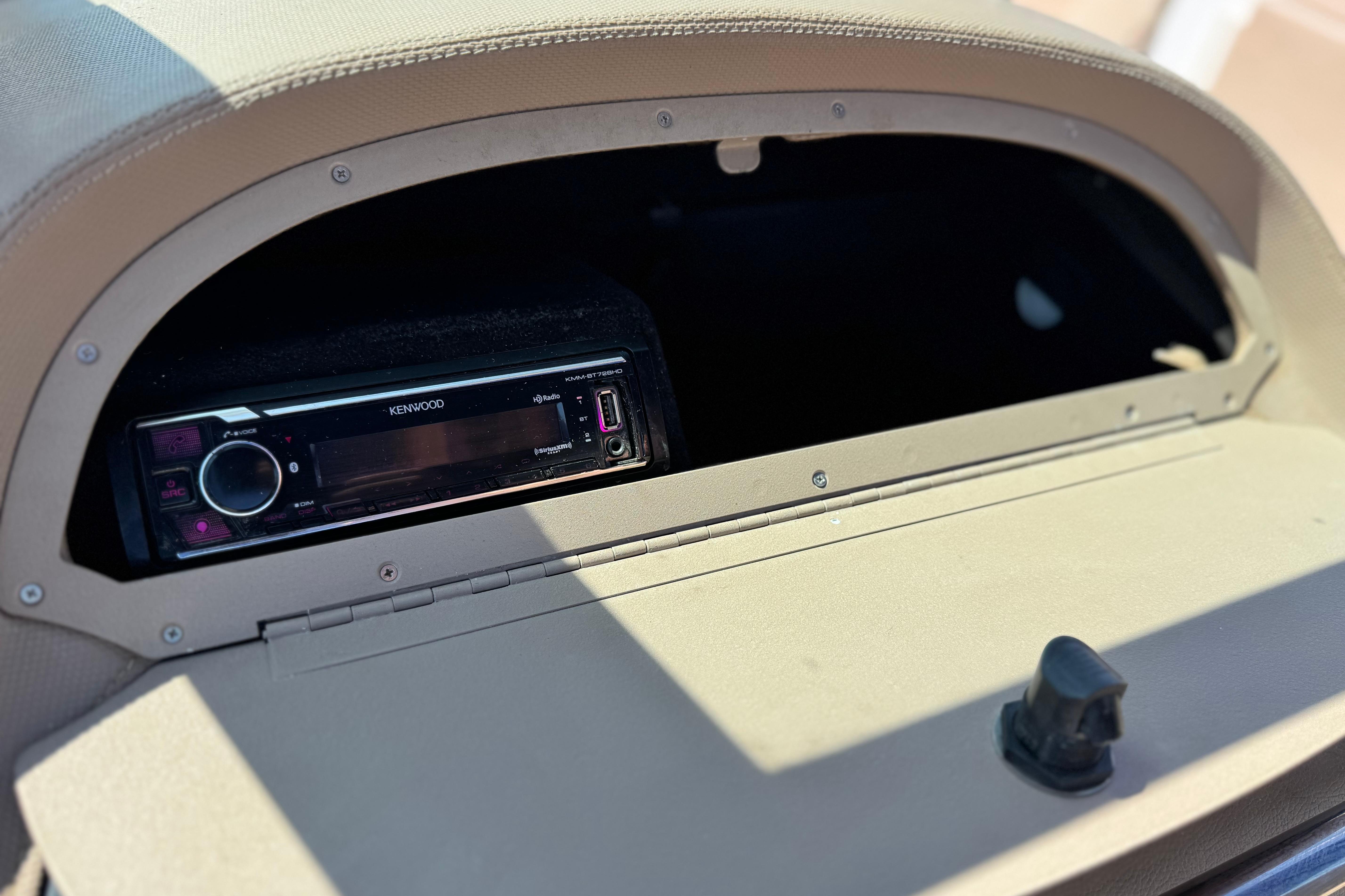 Kenwood stereo system in a 2008 Cobalt 262 boat dashboard compartment.