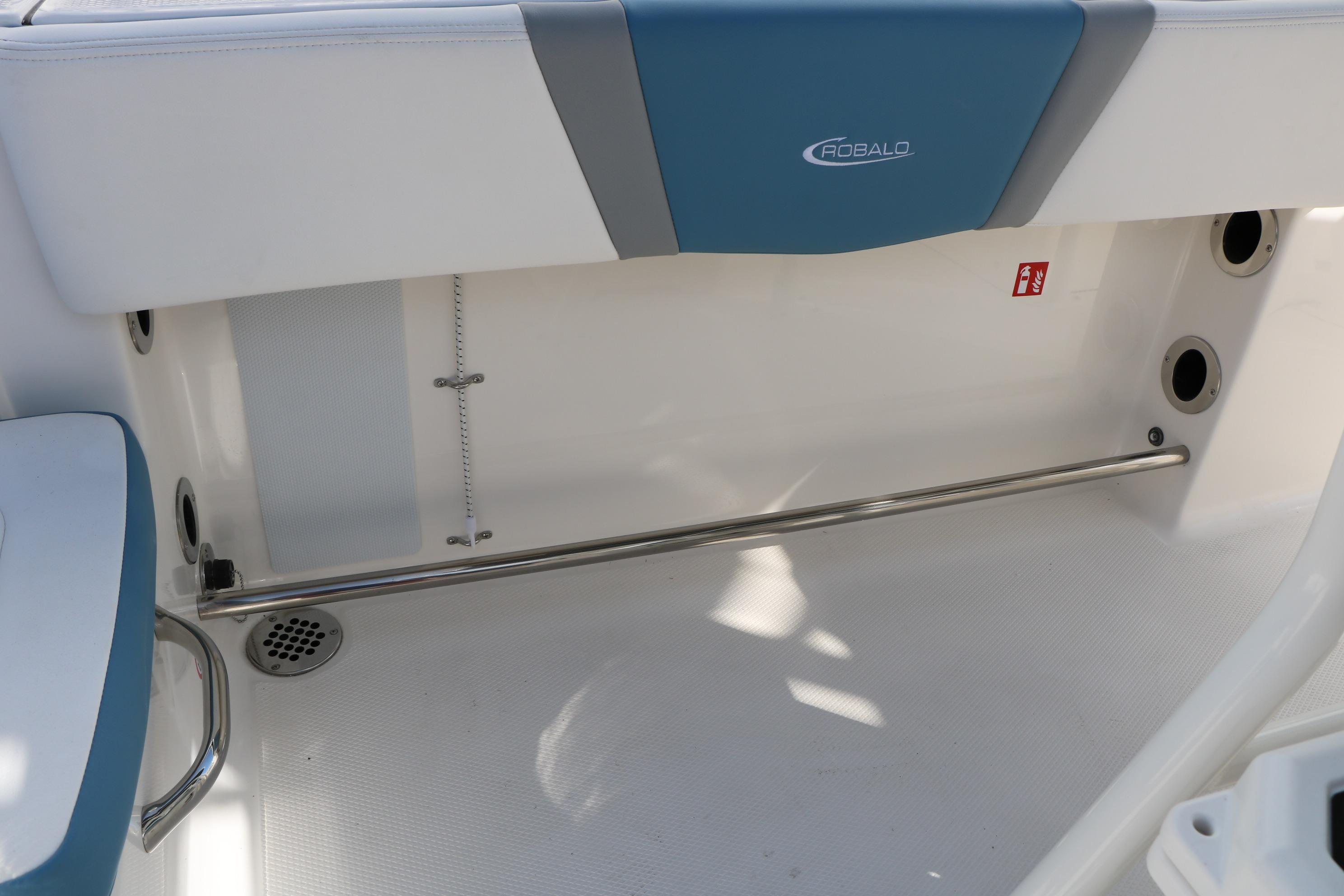 2026 Robalo R200 Center Console interior detail with stainless steel rail and drainage.